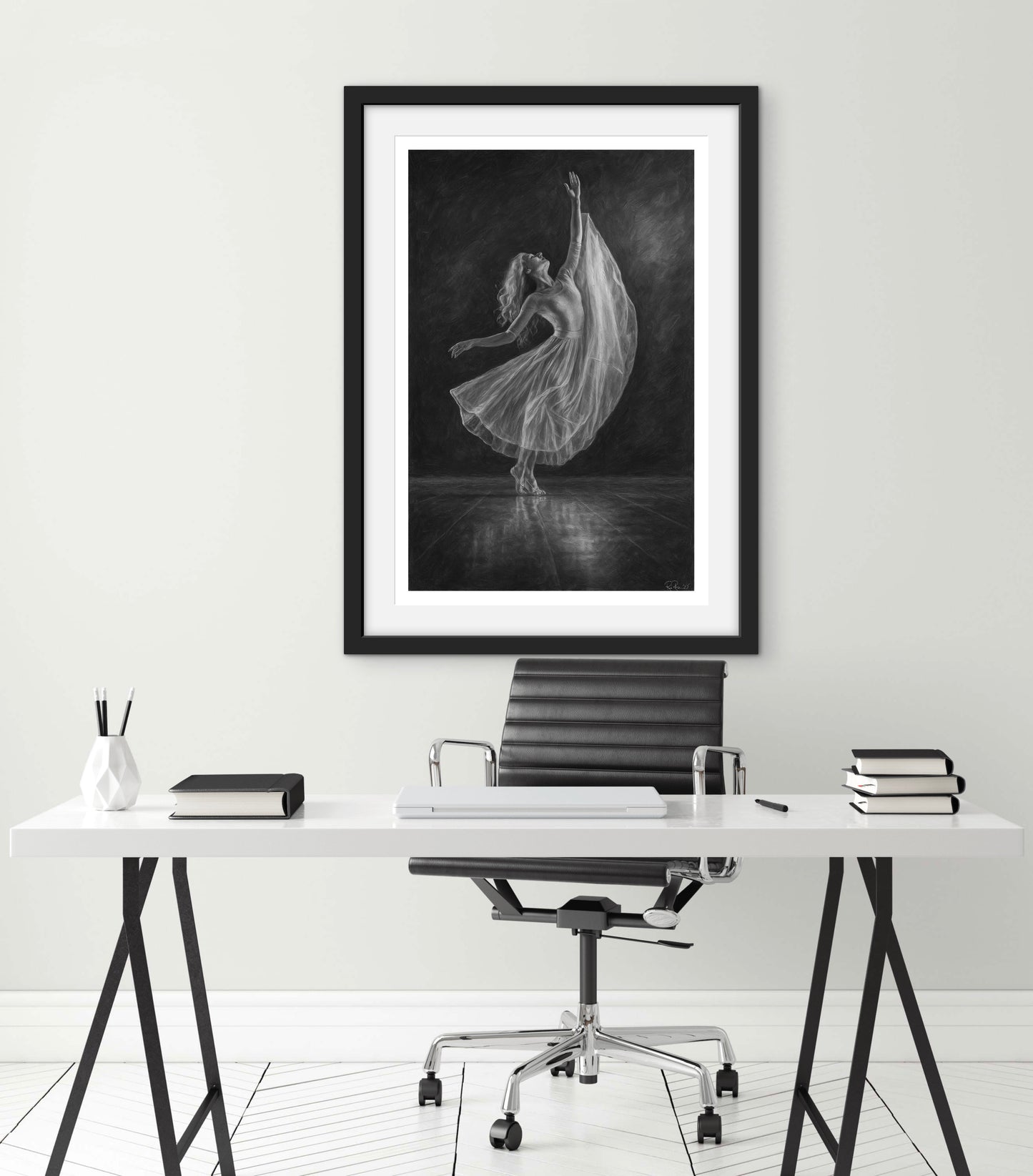 Framed black and white artwork of a dancer in a modern office setting.