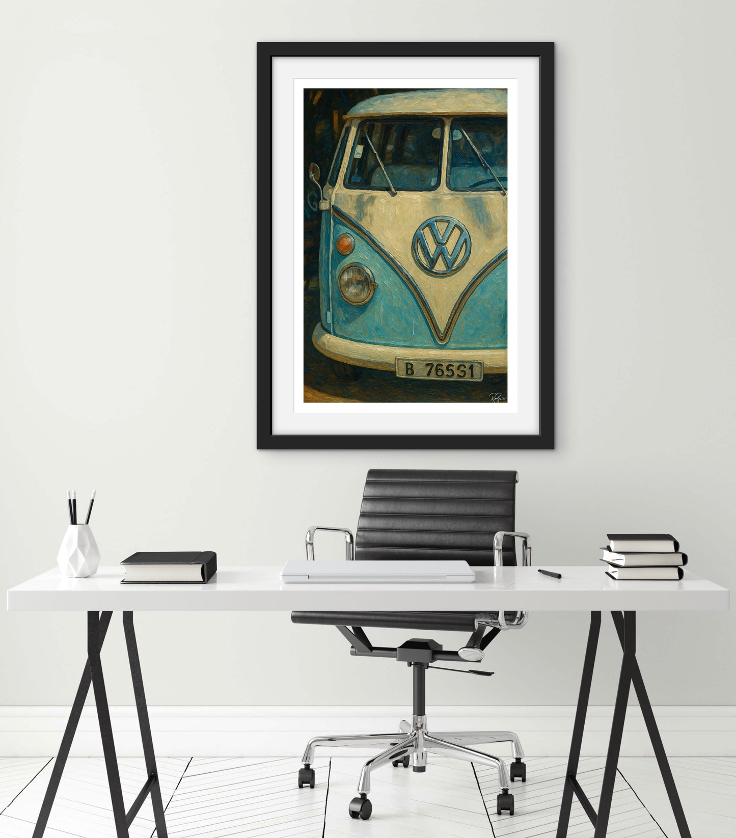 Framed artwork of a vintage Volkswagen van on a white wall above a desk.