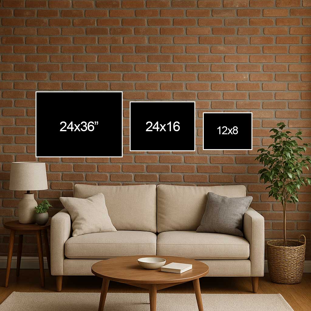 Living room with a beige sofa, round wooden coffee table, and three black frames on a brick wall.