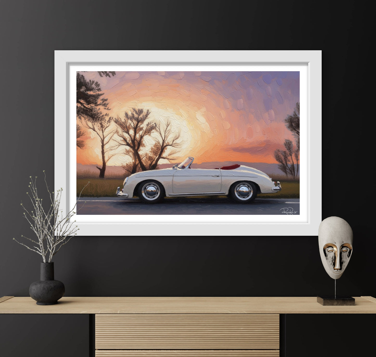 Framed artwork of a classic car at sunset with decorative items on a shelf.