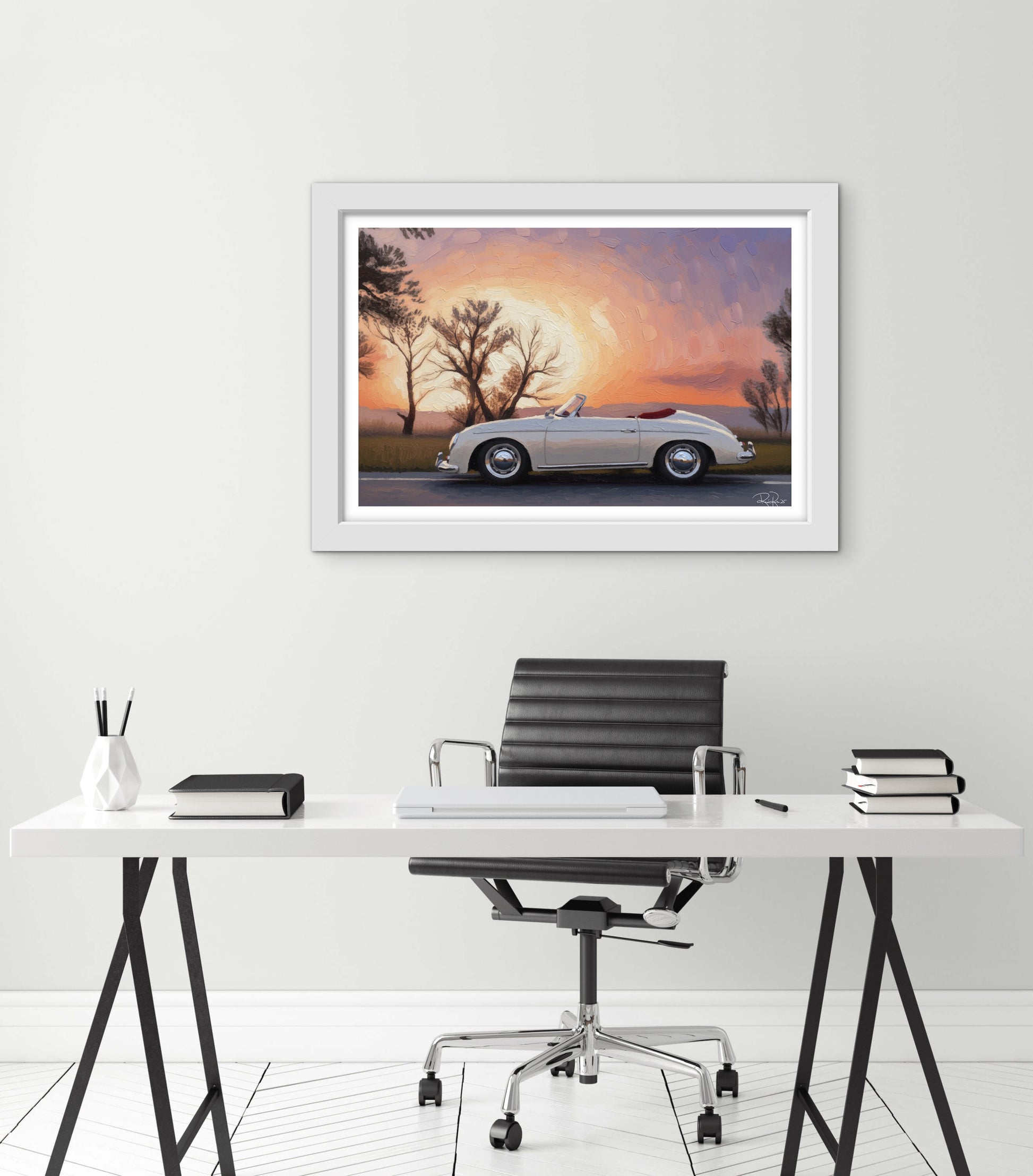 Framed artwork of a vintage car at sunset above a desk with office furniture.