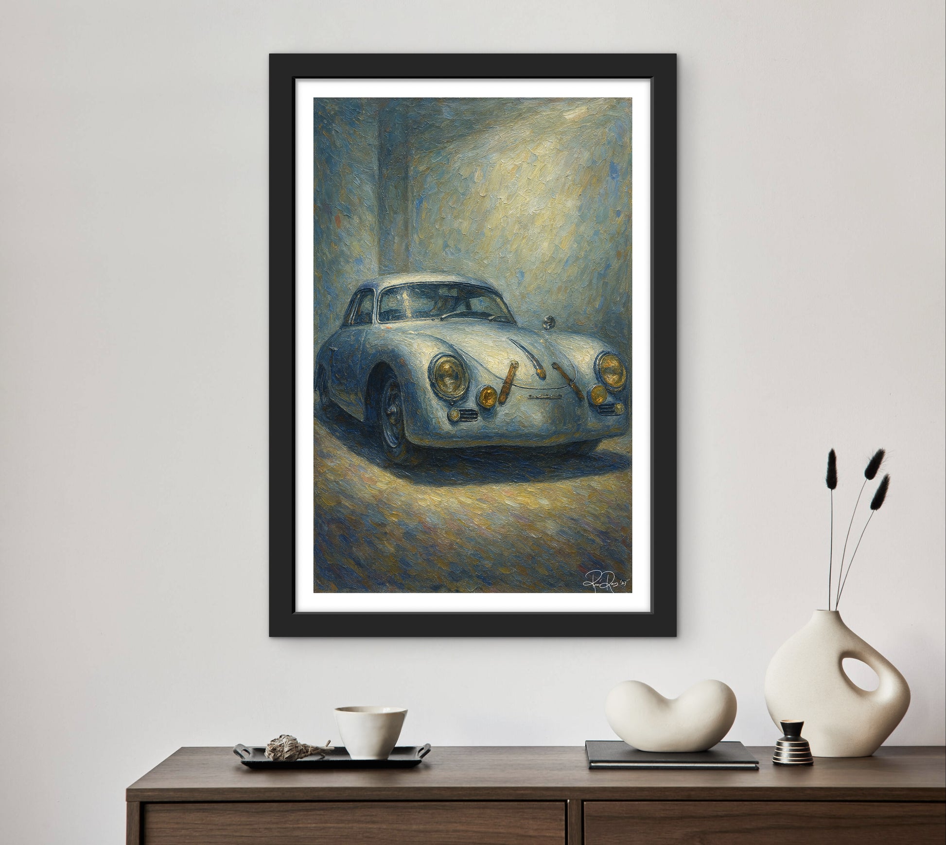 Framed painting of a vintage car on a wall above a wooden console table with decorative items.