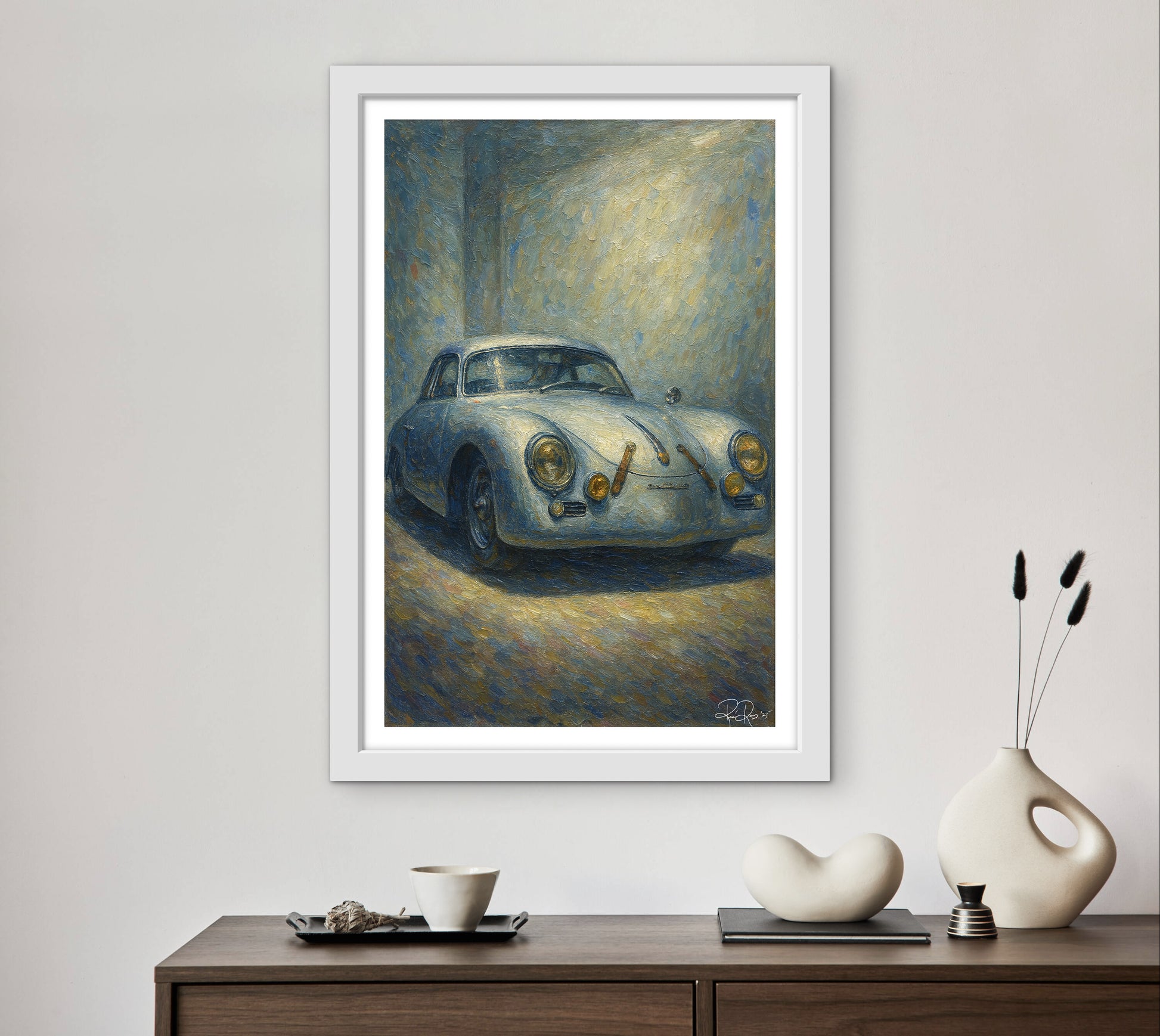 Framed painting of a vintage car on a wall above a wooden console table with decorative items.