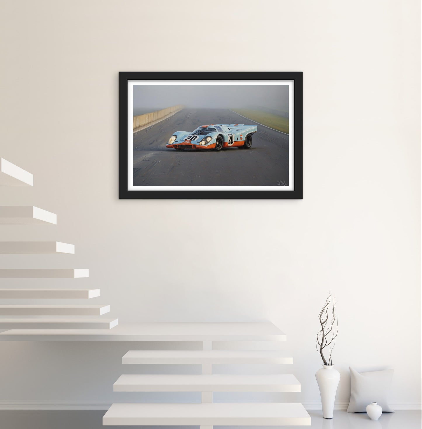 Framed photograph of a race car on a track in a modern interior setting.