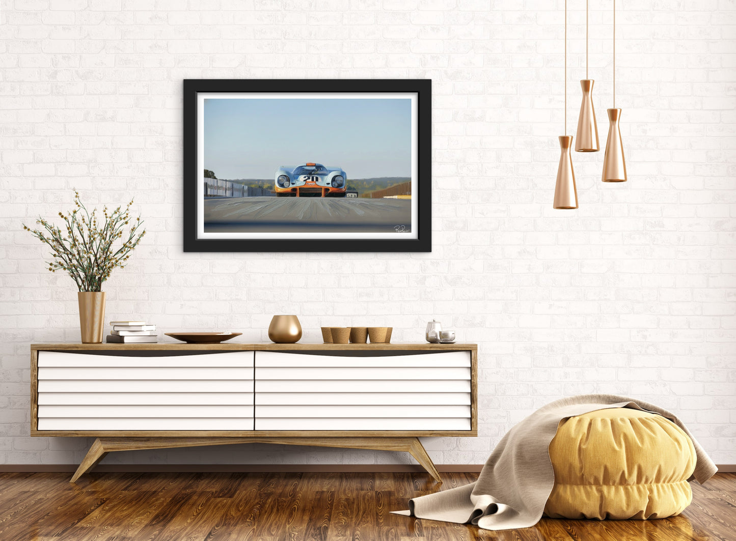 Framed artwork of a car on a road in a modern living room setting.