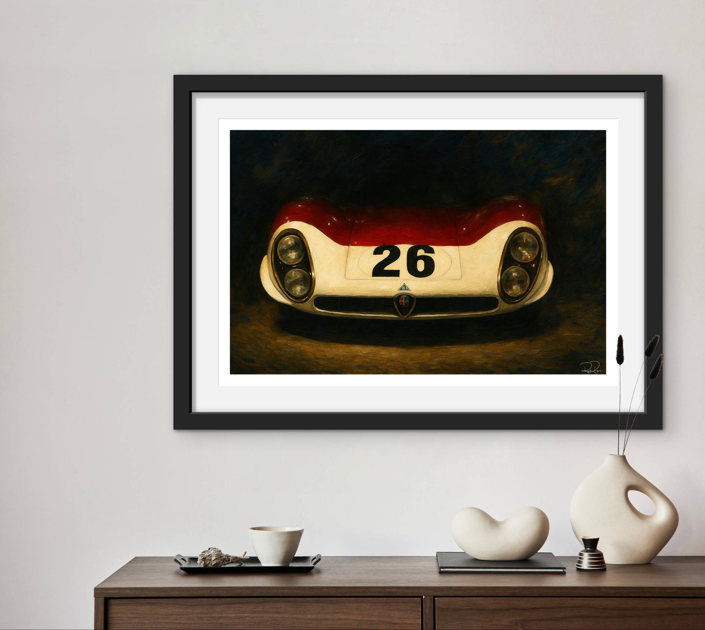 Framed artwork of a vintage race car with the number 26 on a wall above a wooden console table.