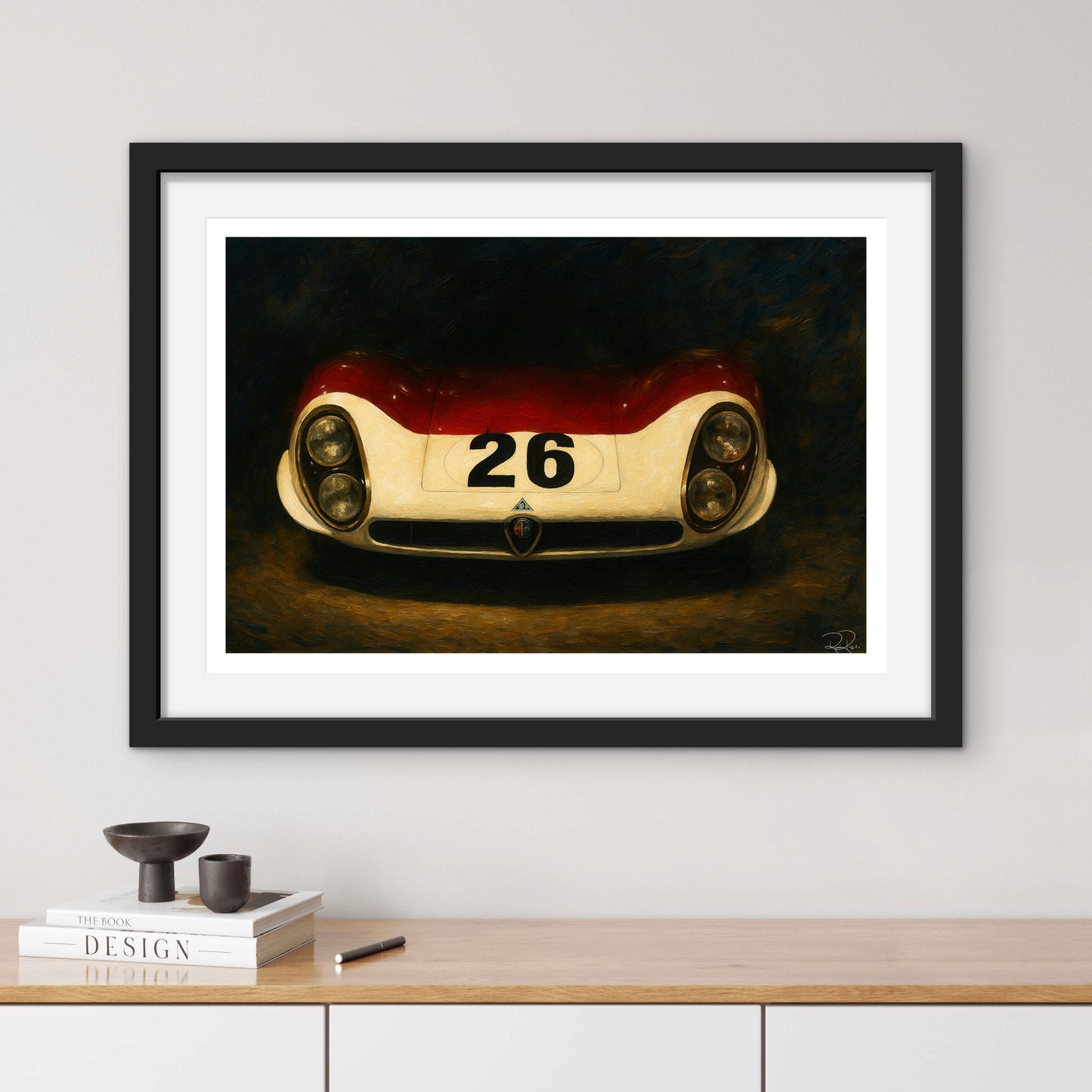 Framed artwork of a vintage race car with number 26 on a wall above a wooden shelf.