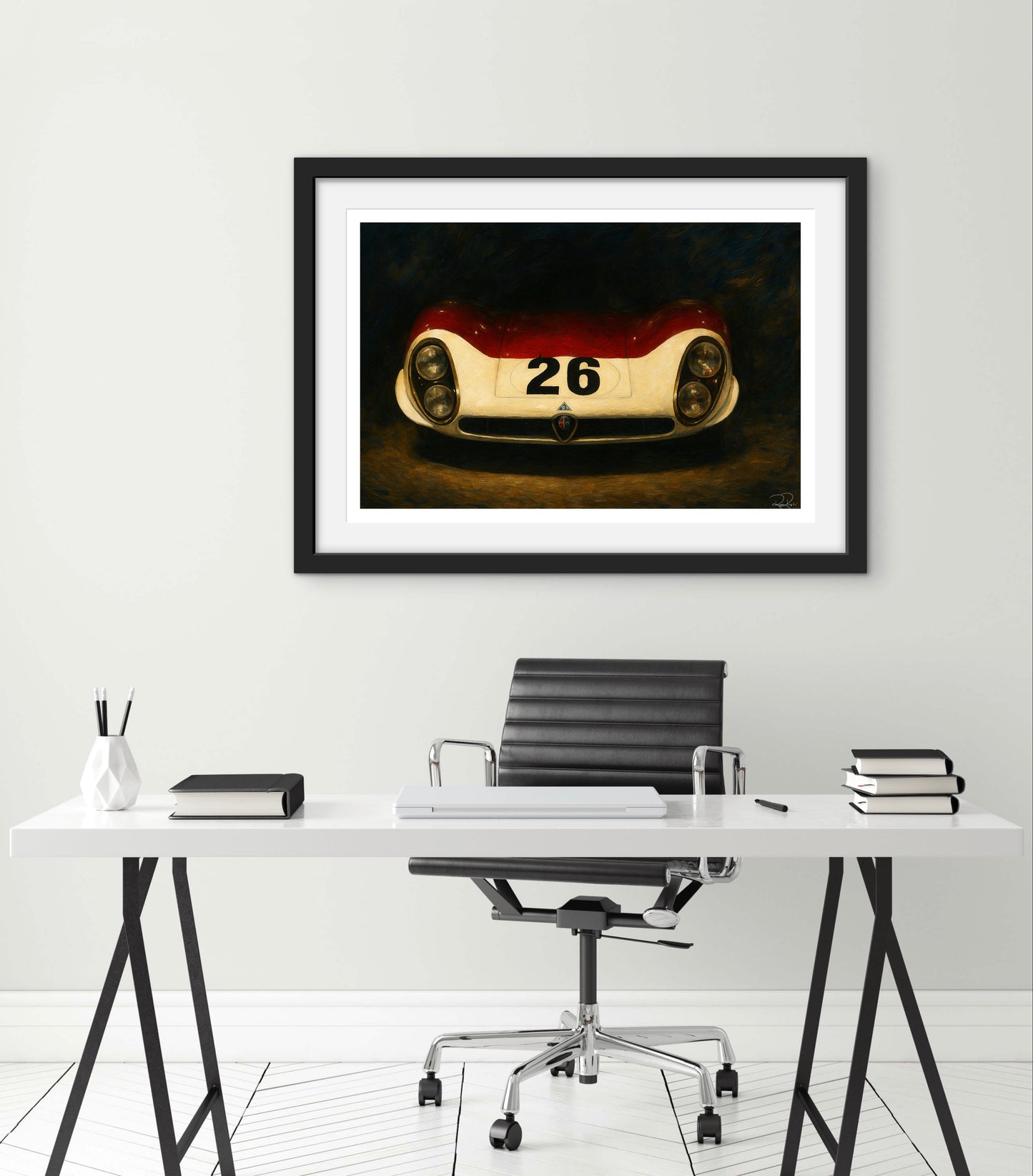 Framed artwork of a vintage race car on a wall above a desk.
