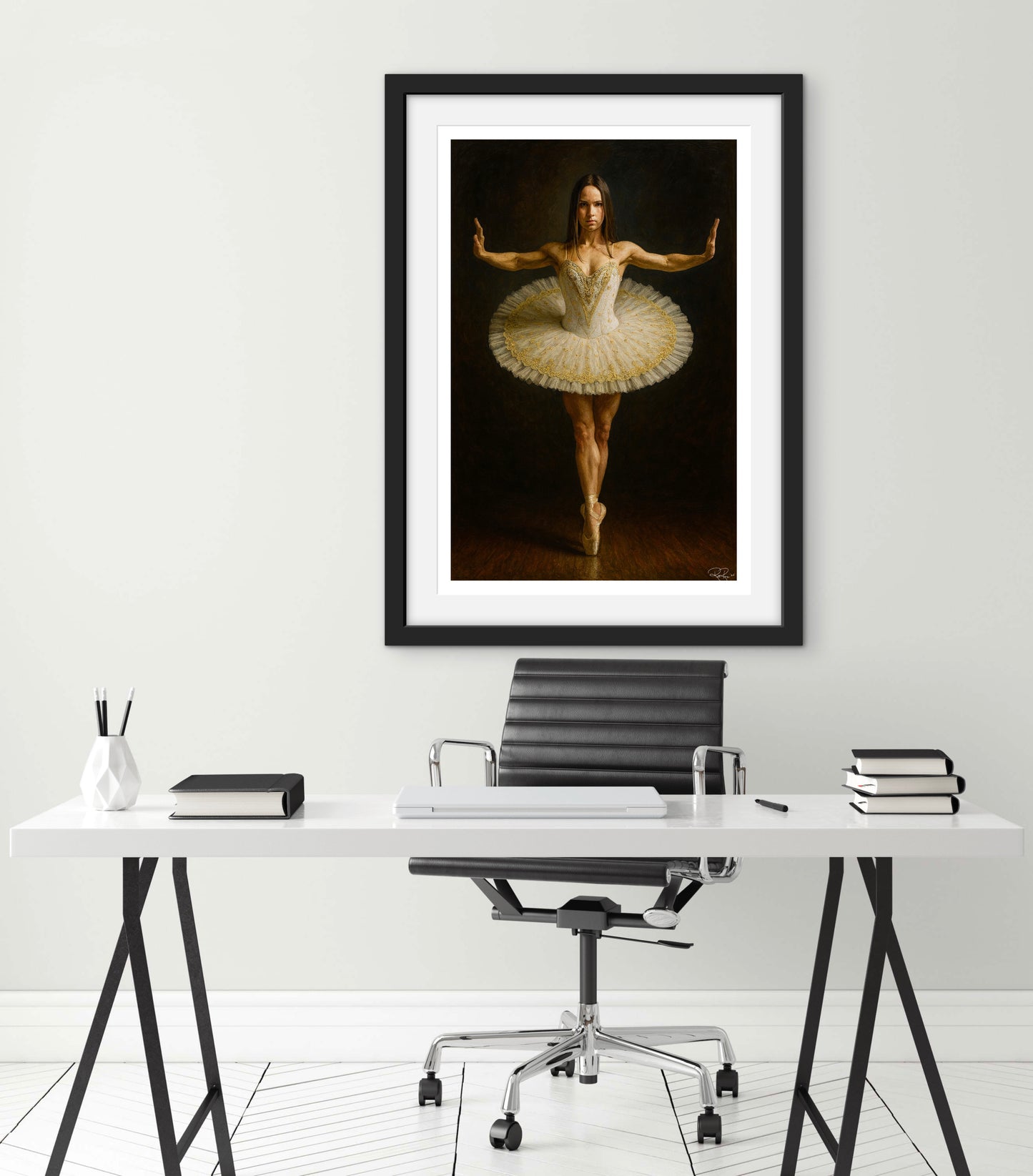 Framed artwork of a ballerina in a dance pose above a desk with office furniture.