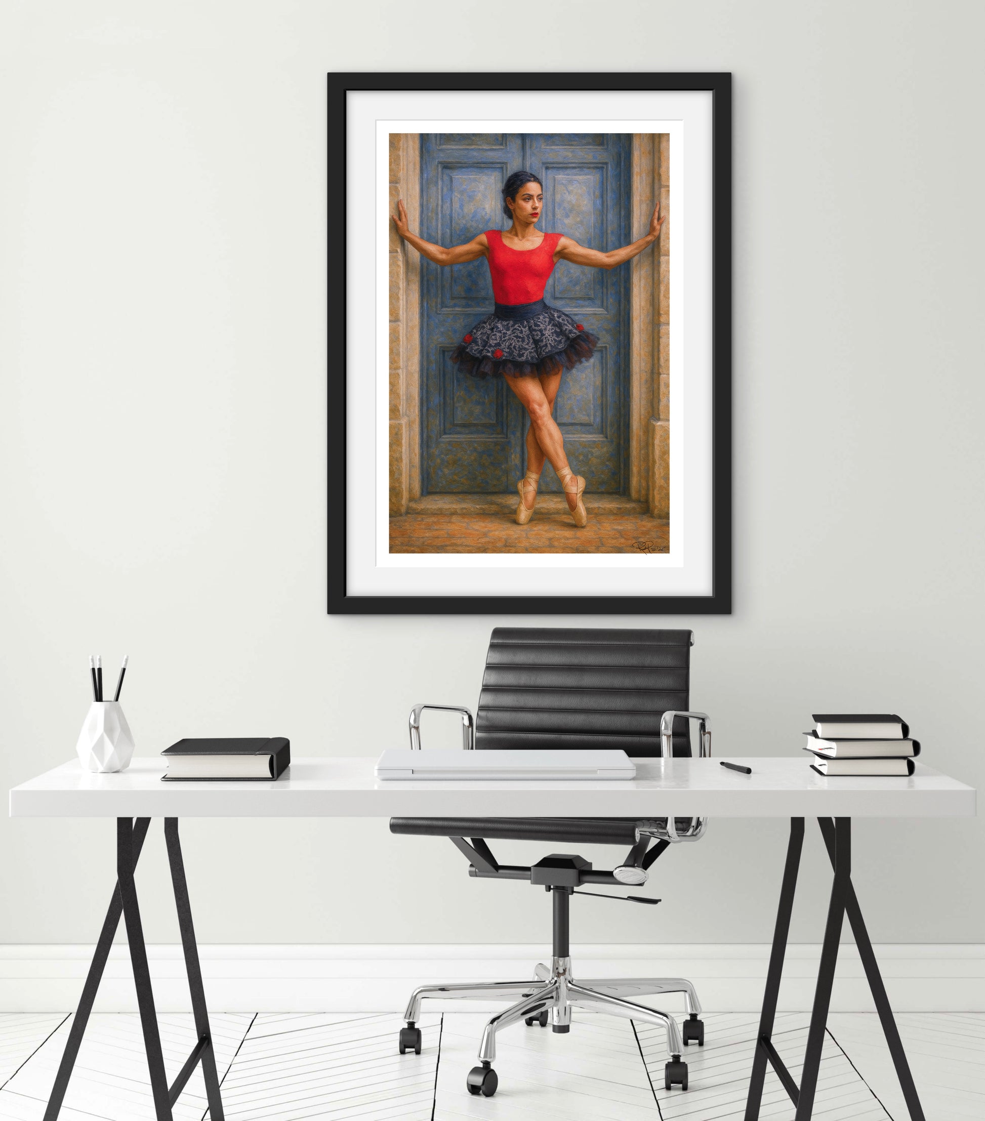 Framed artwork of a ballerina on a wall above a desk with office furniture.