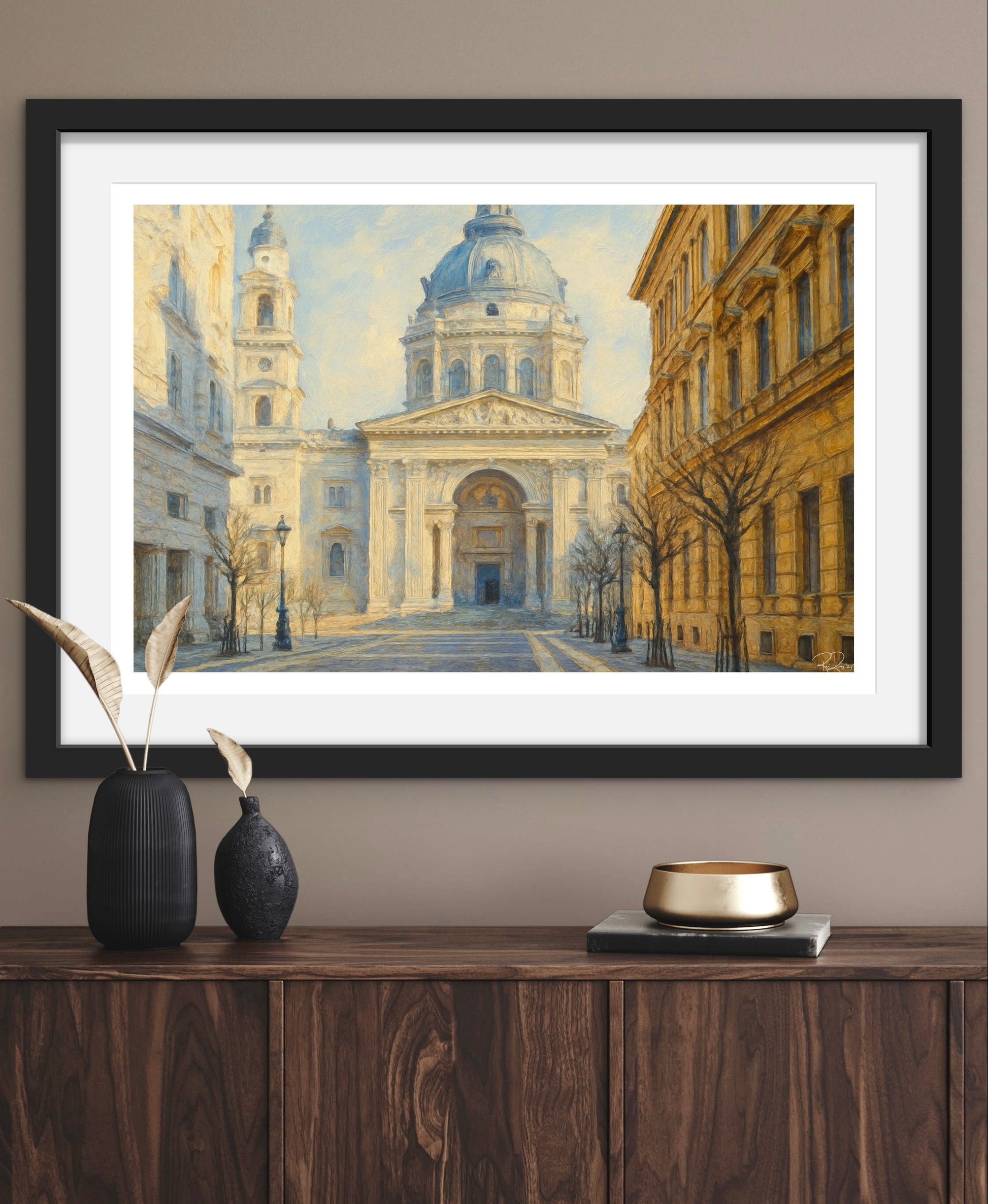Framed artwork of a classical building on a wooden console table with decorative items.