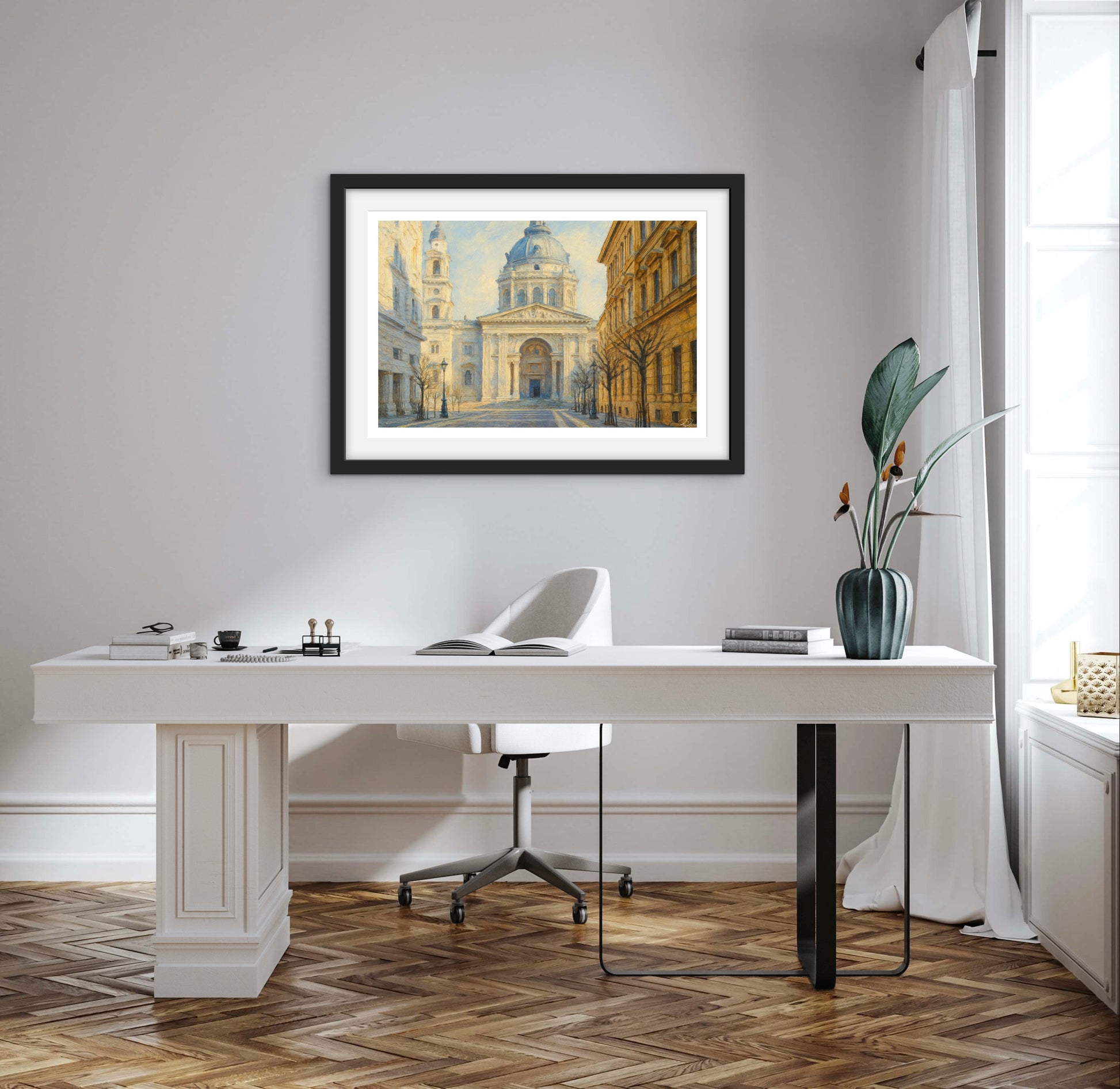 Modern office setup with a white desk, chair, and framed artwork on a wall.