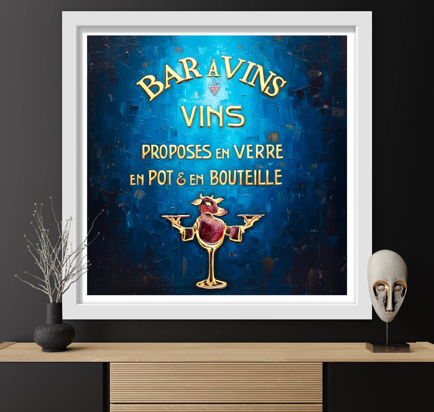 Framed vintage-style wine advertisement poster on a dark wall with decorative items.