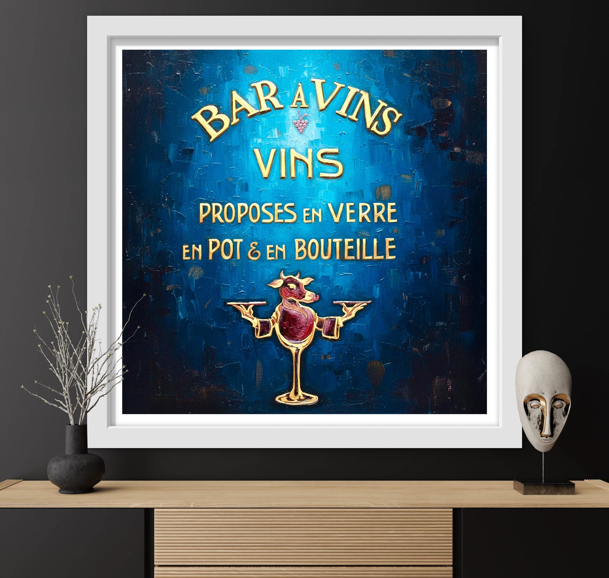 Framed vintage-style wine advertisement poster on a dark wall with decorative items.