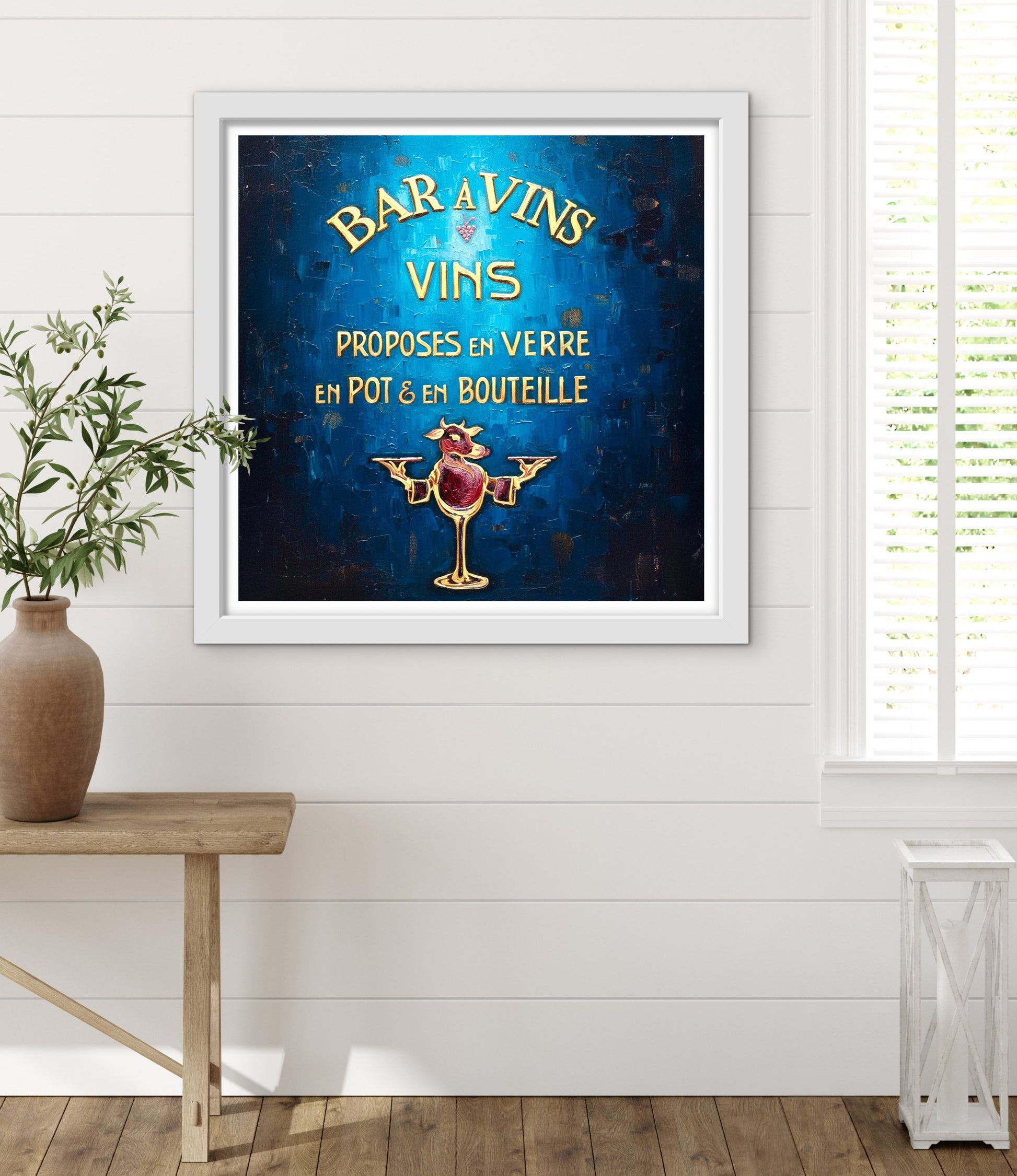 Framed artwork with text and a rooster illustration on a white wall.