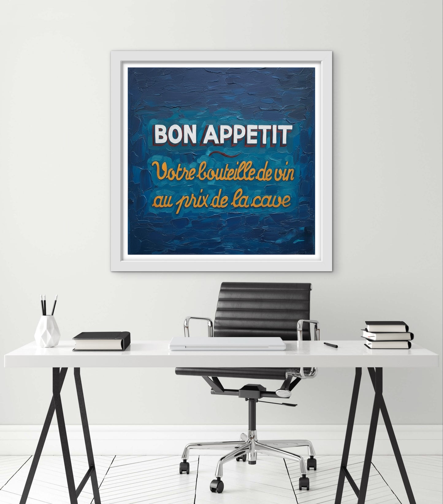 Framed artwork with 'Bon Appetit' text above a desk in an office setting