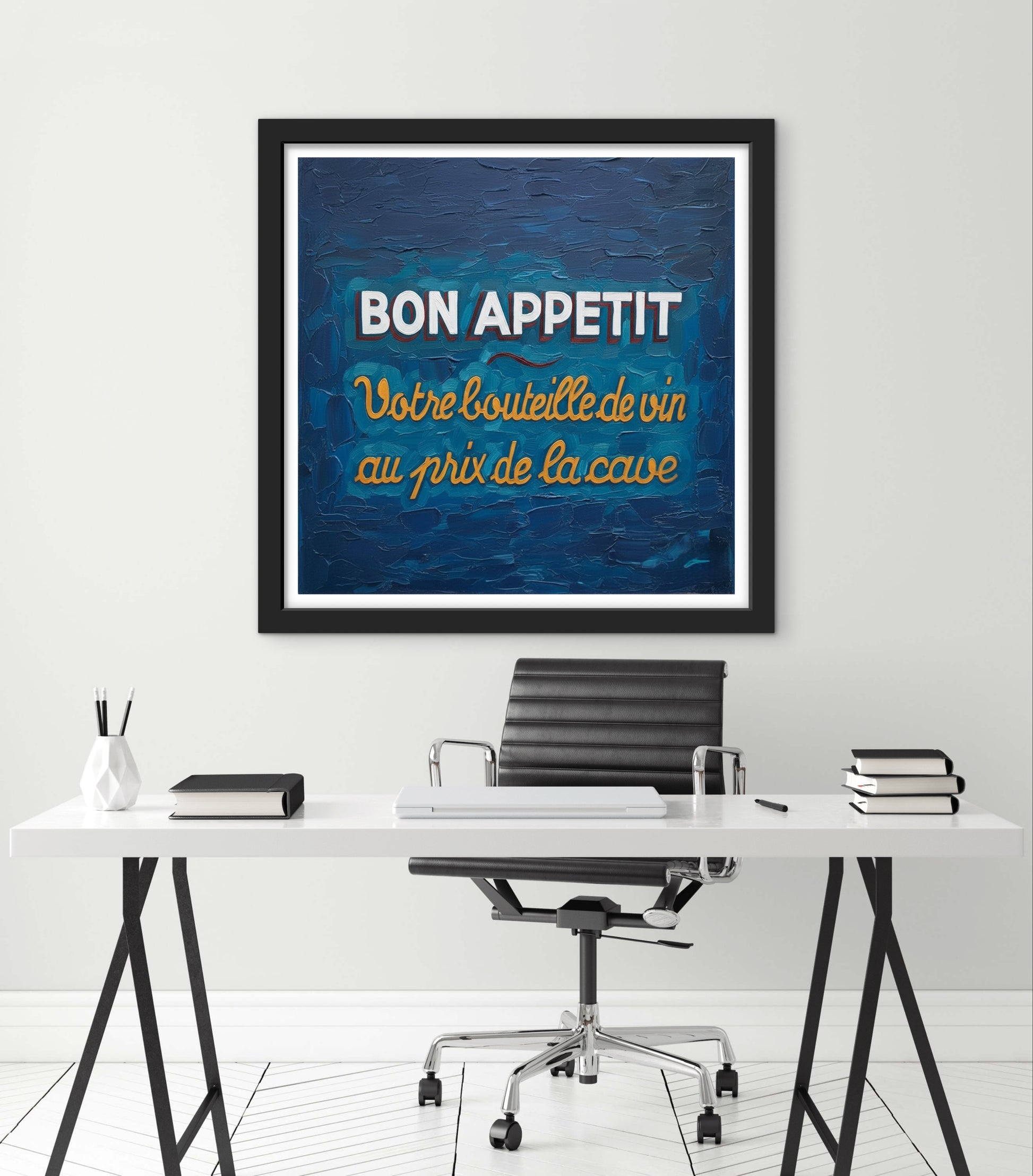 Framed artwork with 'Bon Appetit' text above a desk in an office setting