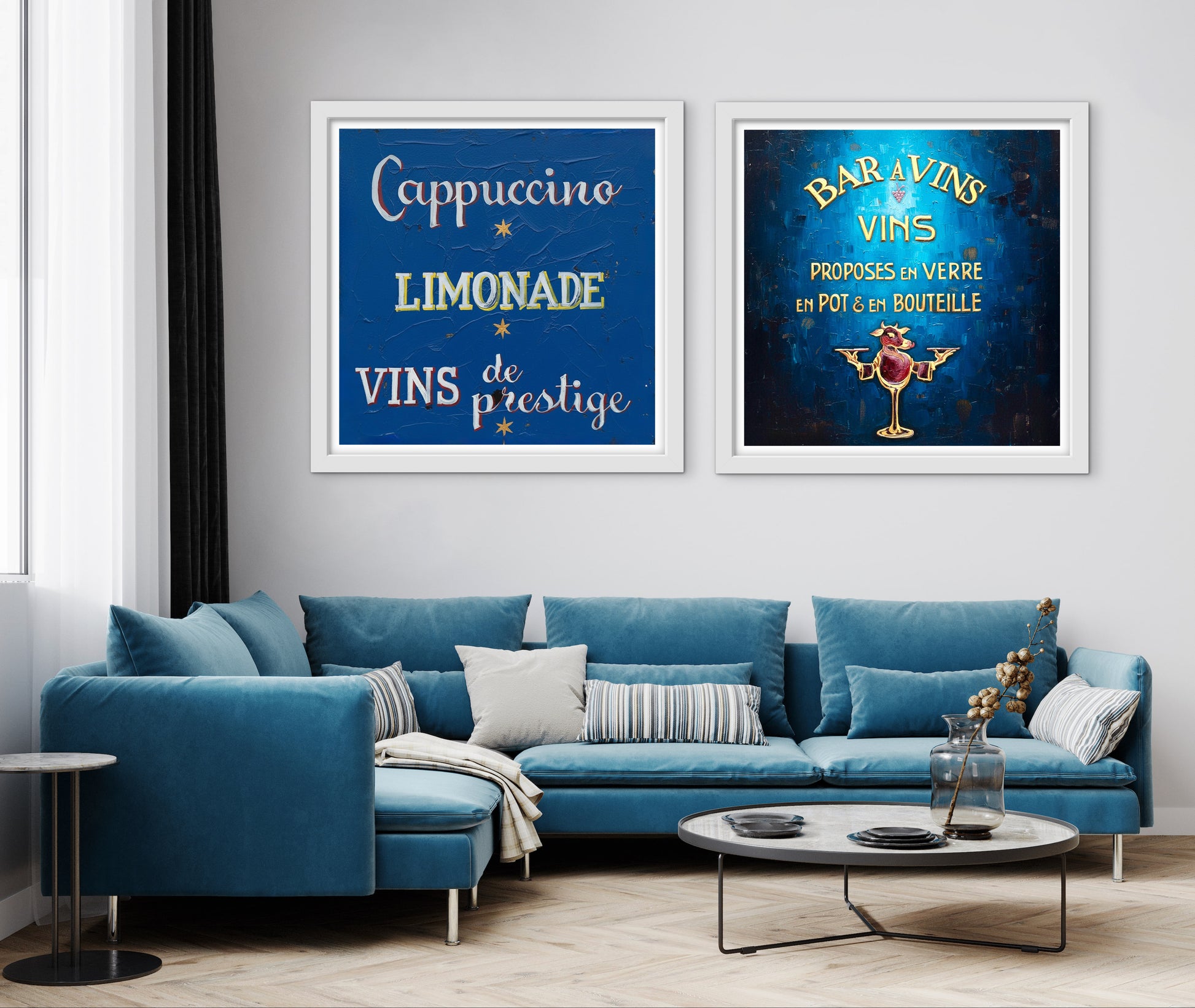 Blue sofa in a living room with two framed posters on the wall.