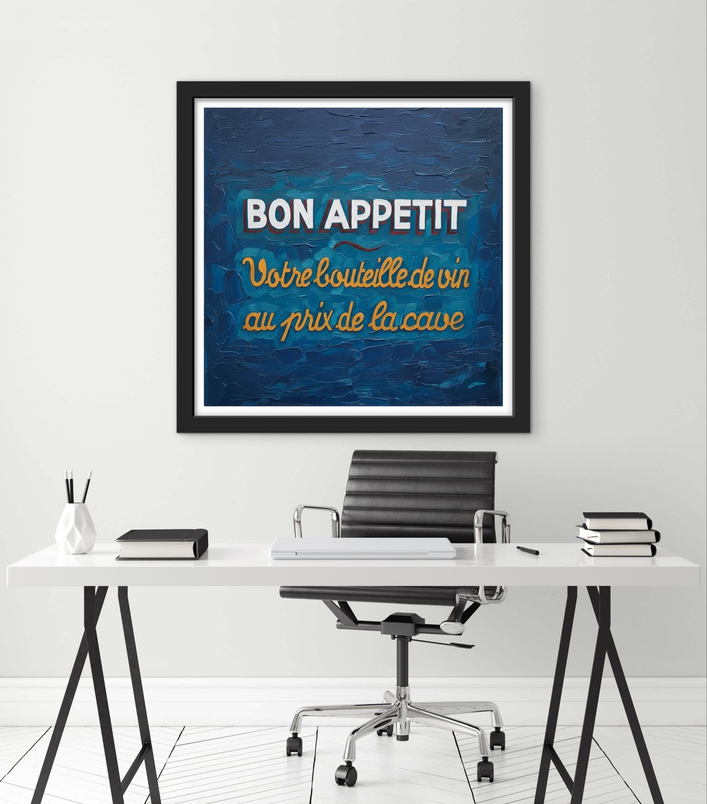 Framed artwork with 'Bon Appetit' text above a desk in an office setting