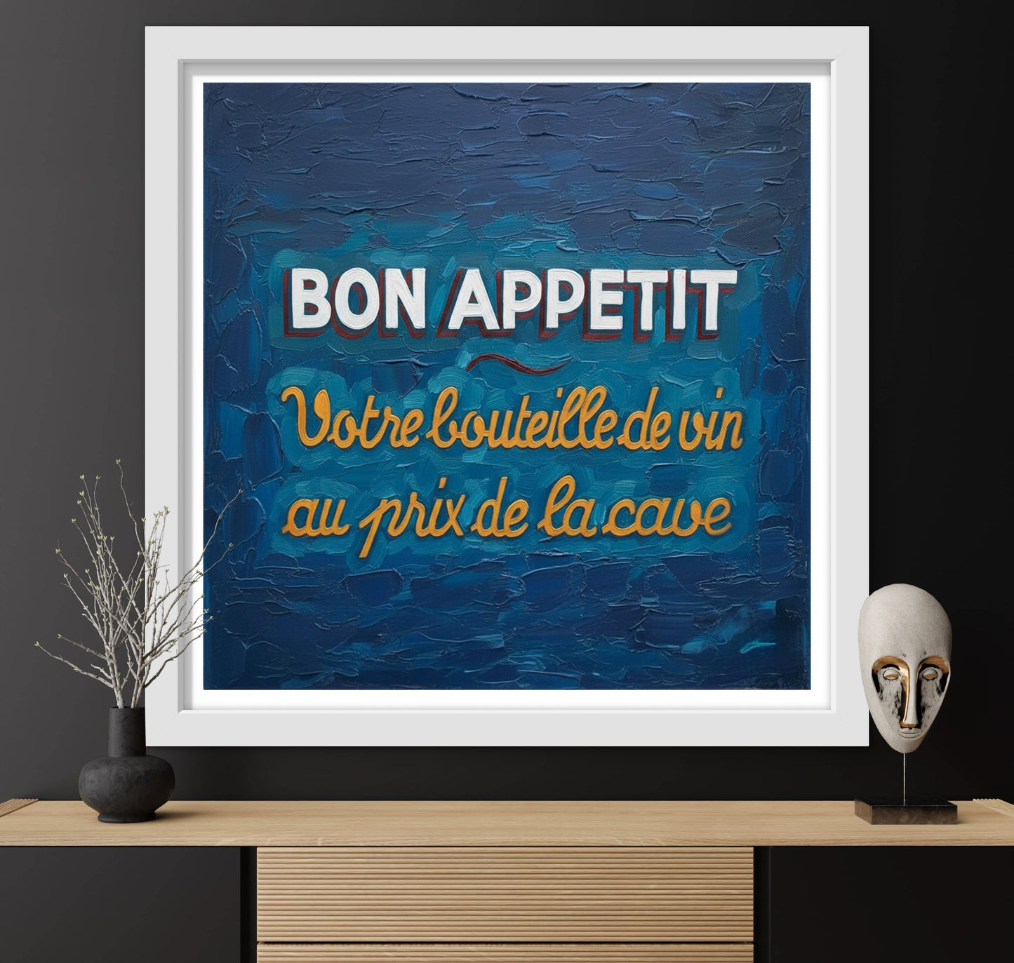 Framed artwork with 'Bon Appetit' text on a blue background, displayed on a shelf.
