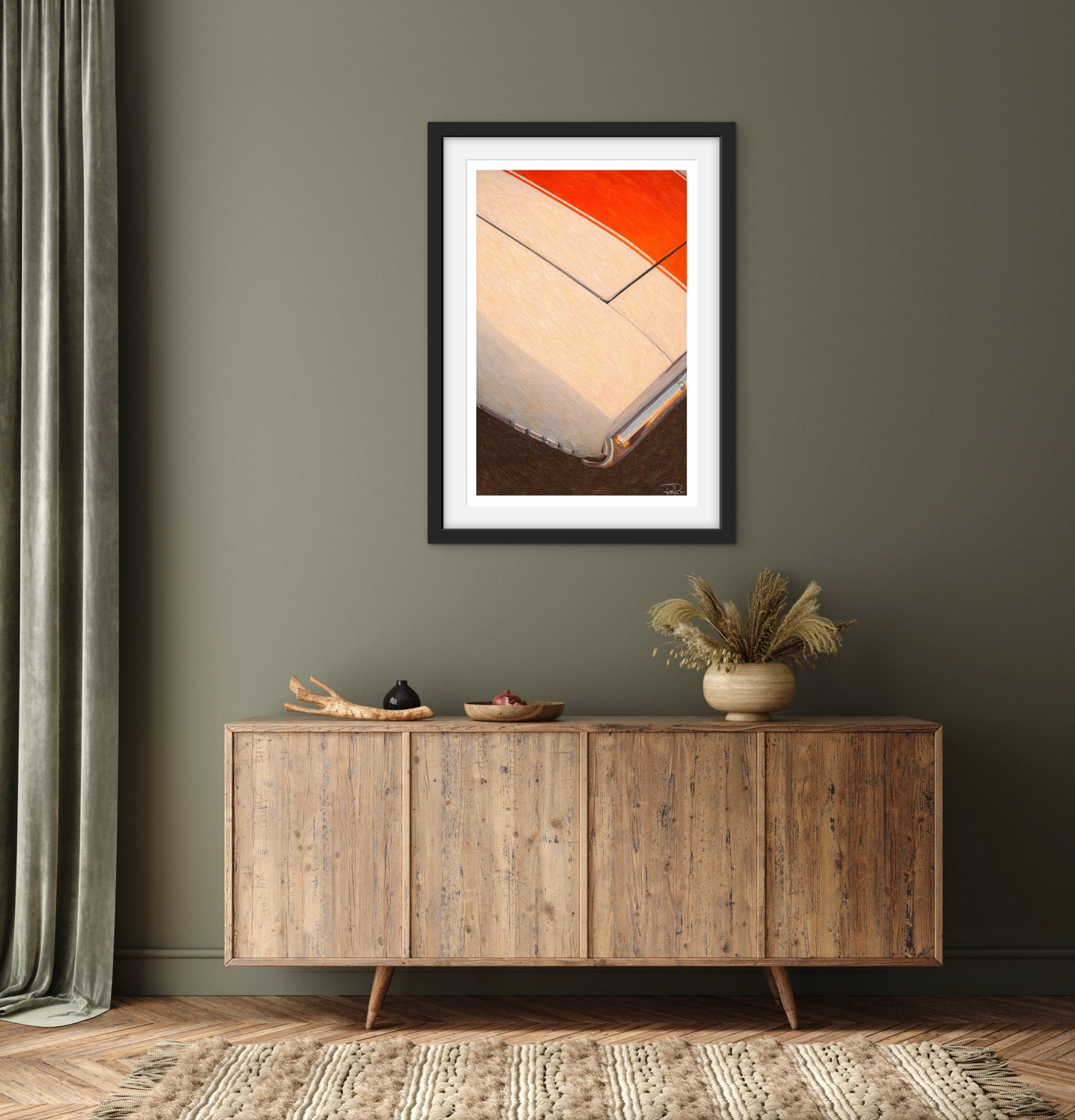 Framed abstract art above a wooden sideboard in a room with a gray wall.