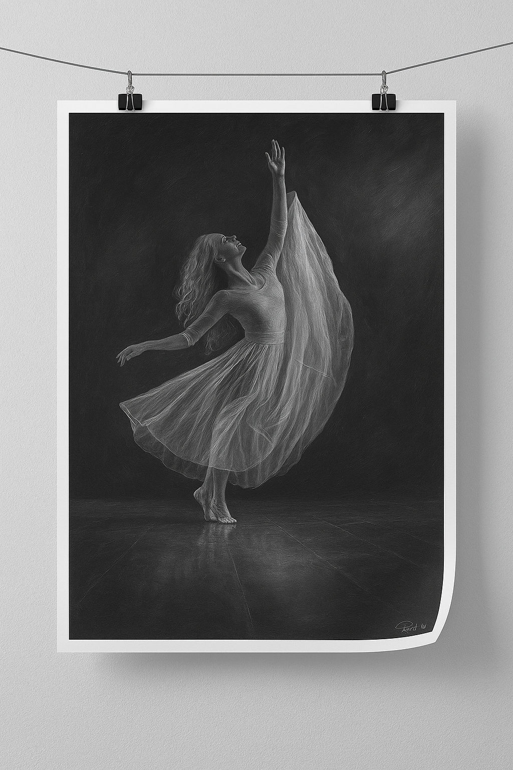 Black and white photograph of a dancer in a flowing dress against a dark background.