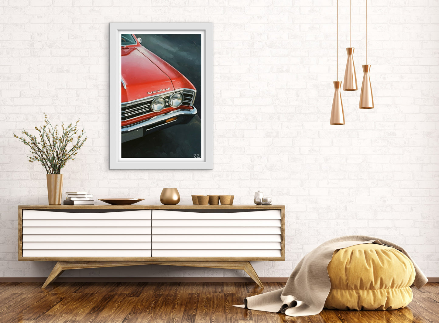 Framed picture of a red car on a wall above a wooden console table with decorative items.