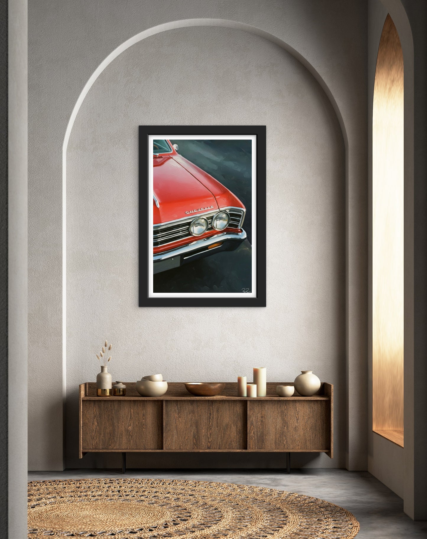 Framed artwork of a red car on a wall above a wooden console table.