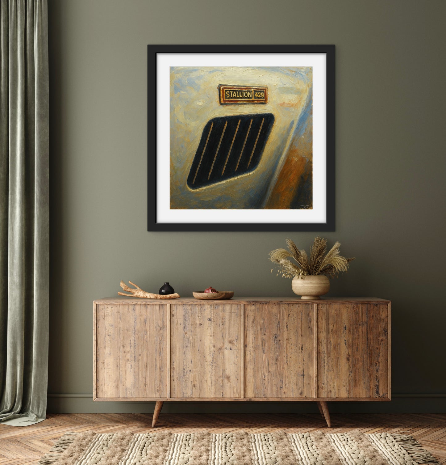 Framed artwork on a wall above a wooden sideboard with decorative items.