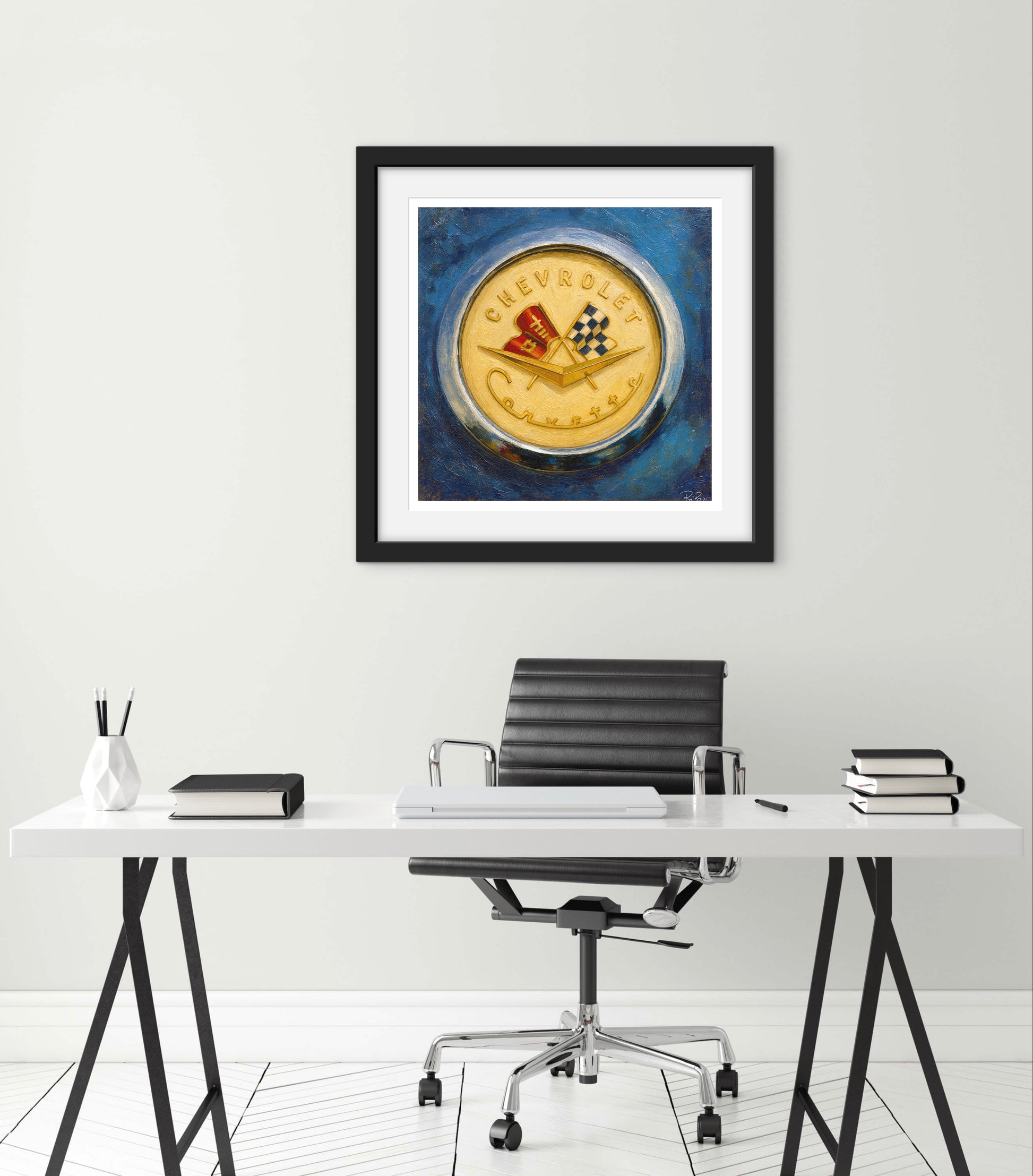 Framed artwork of a vintage Chevrolet logo on a wall above a desk.