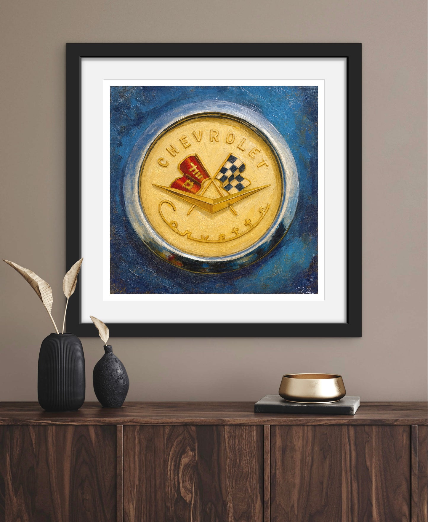 Framed artwork of a Chevrolet emblem on a wall above a wooden cabinet.