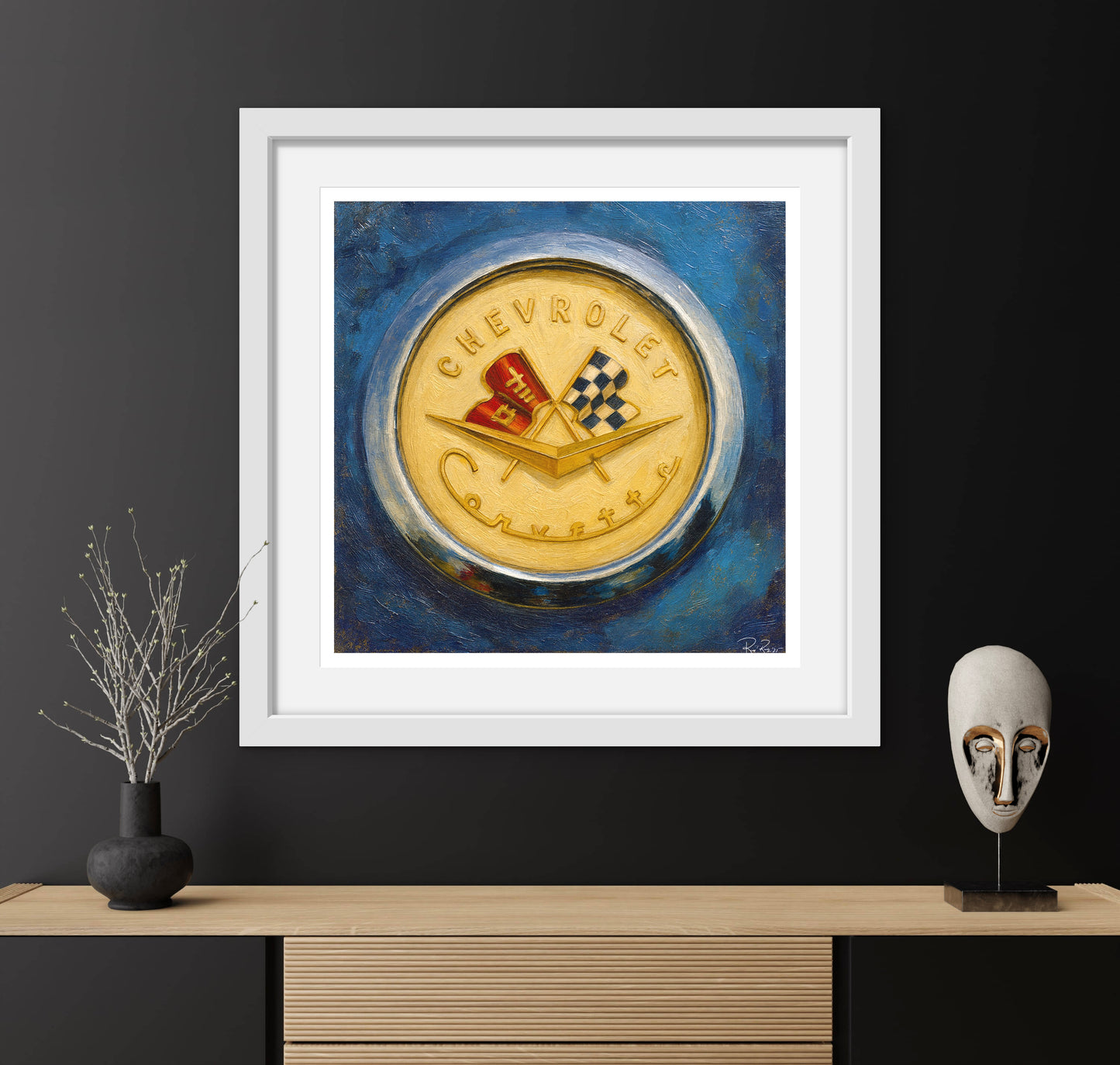 Framed artwork of a Chevrolet logo on a dark wall with decorative items.