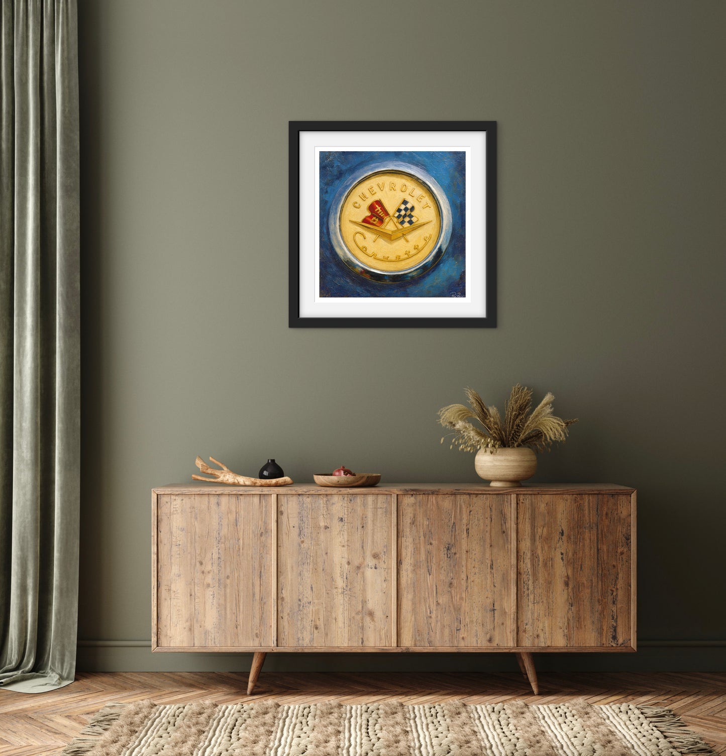 Framed artwork on a wall above a wooden sideboard with decorative items.