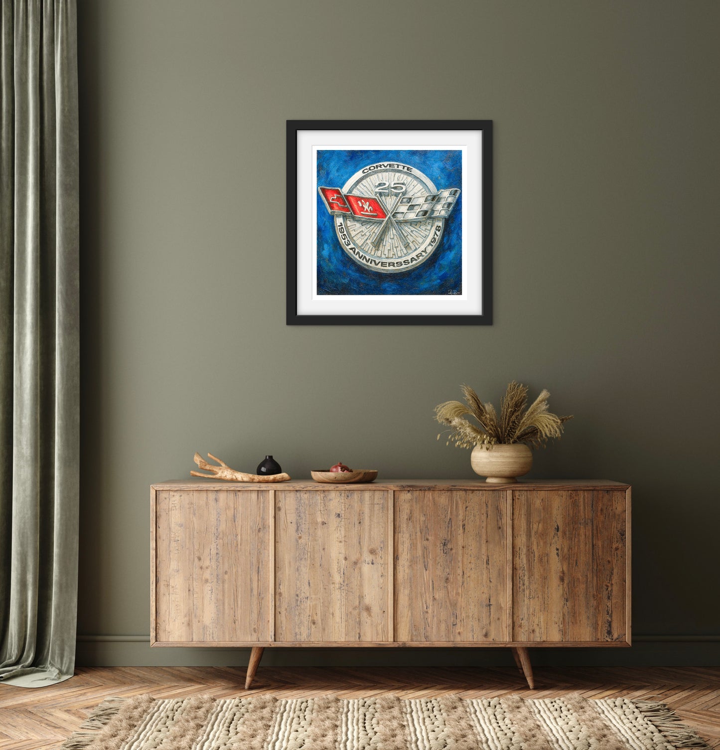 Framed artwork on a wall above a wooden sideboard with decorative items.
