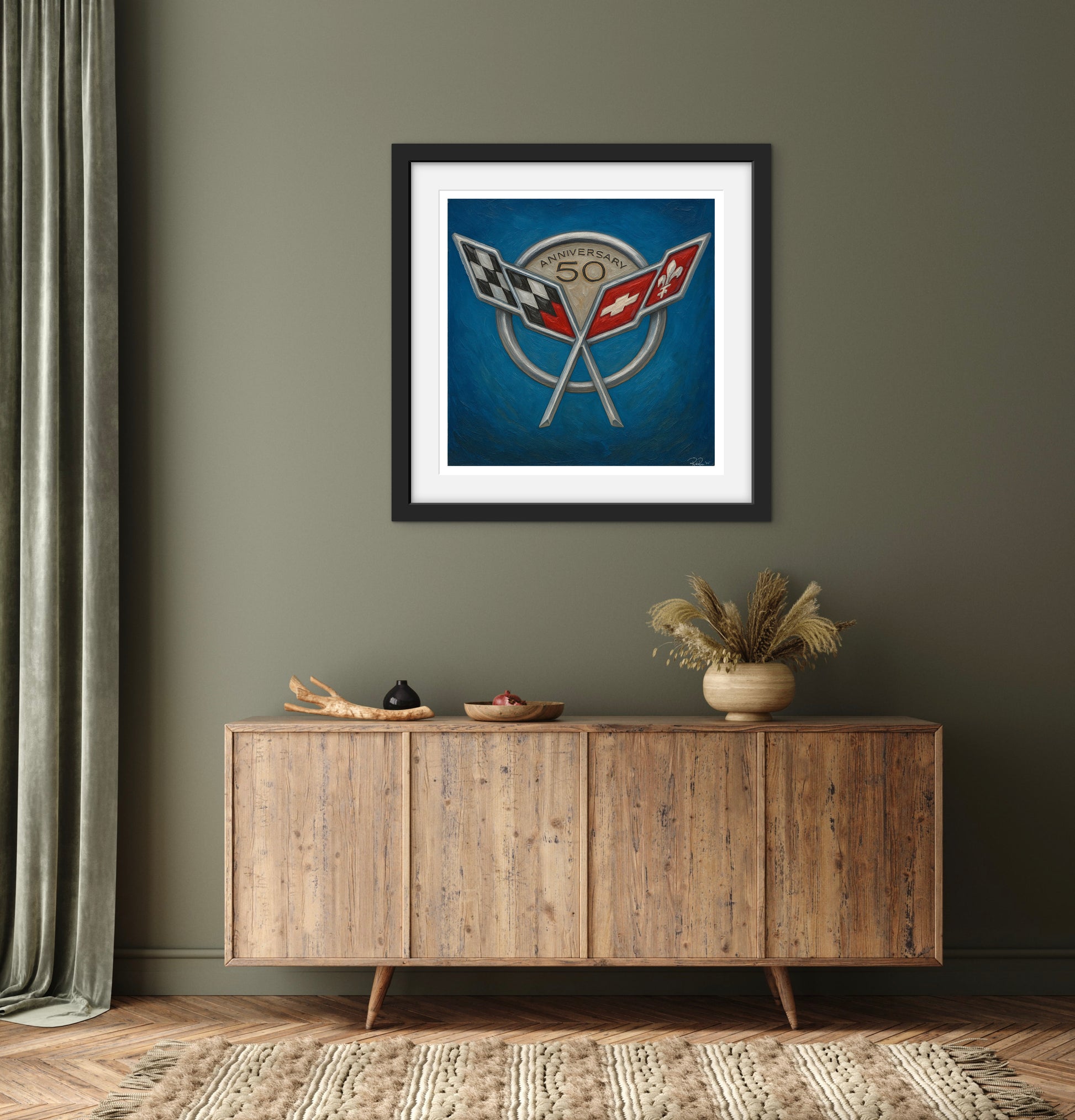 Framed artwork above a wooden sideboard in a room with a gray wall.