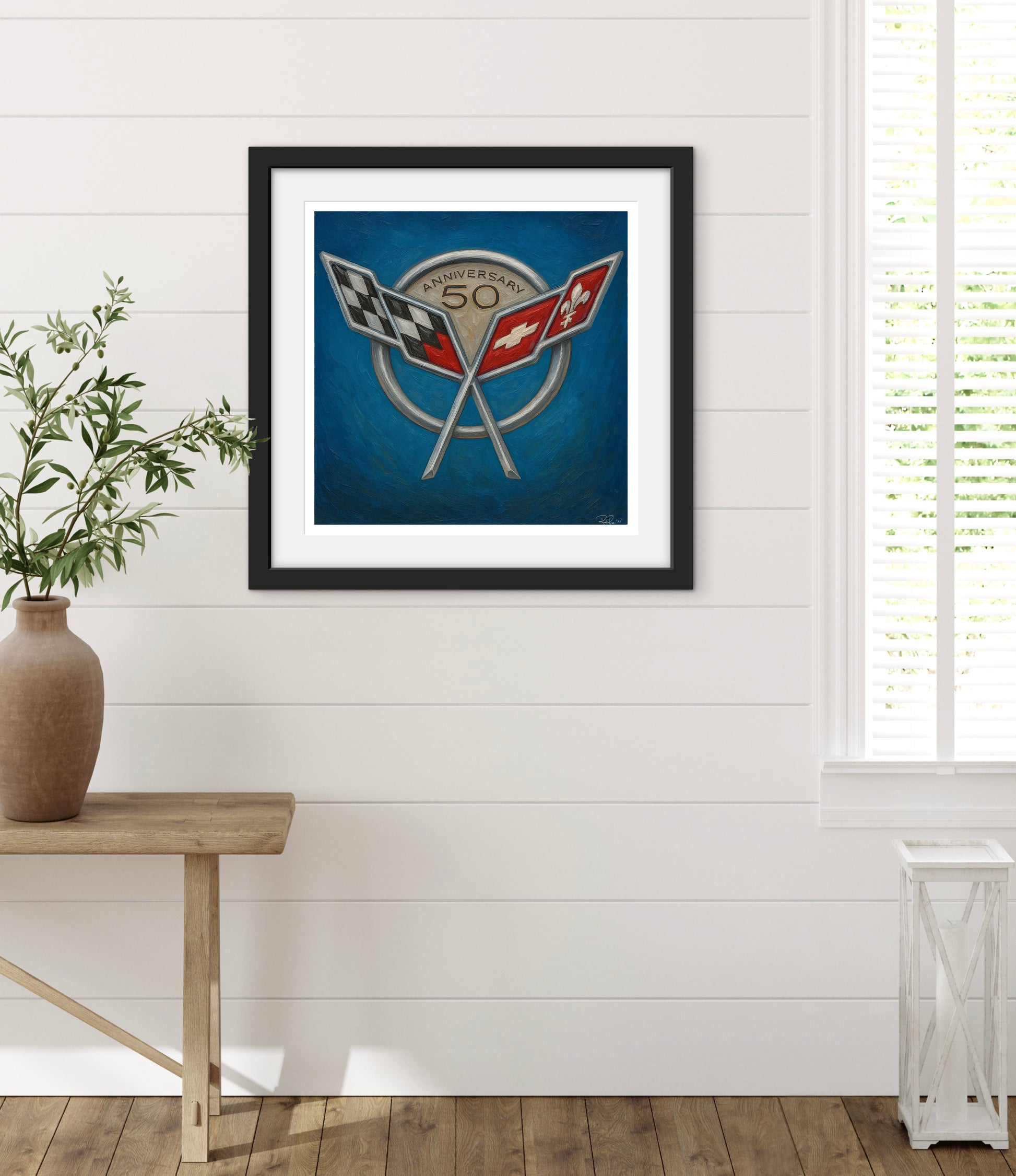 Framed artwork with a racing flag design on a white wall.