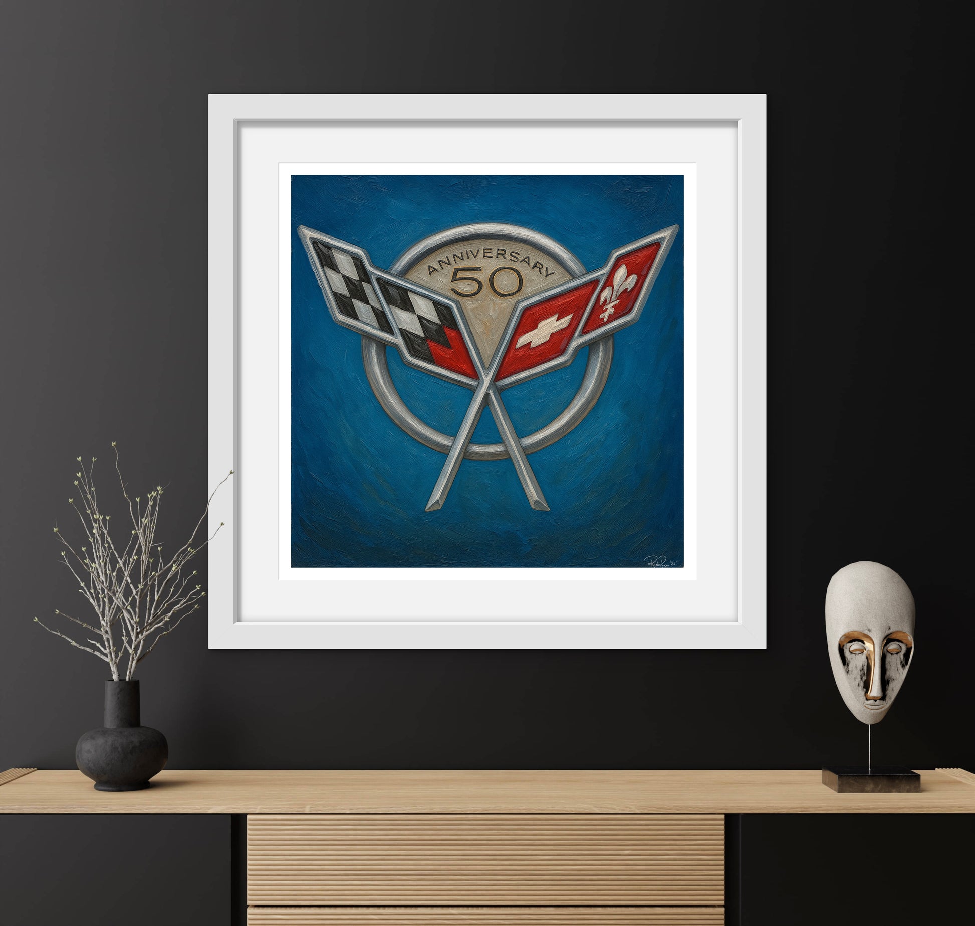 Framed artwork with a logo on a dark wall with decorative items.