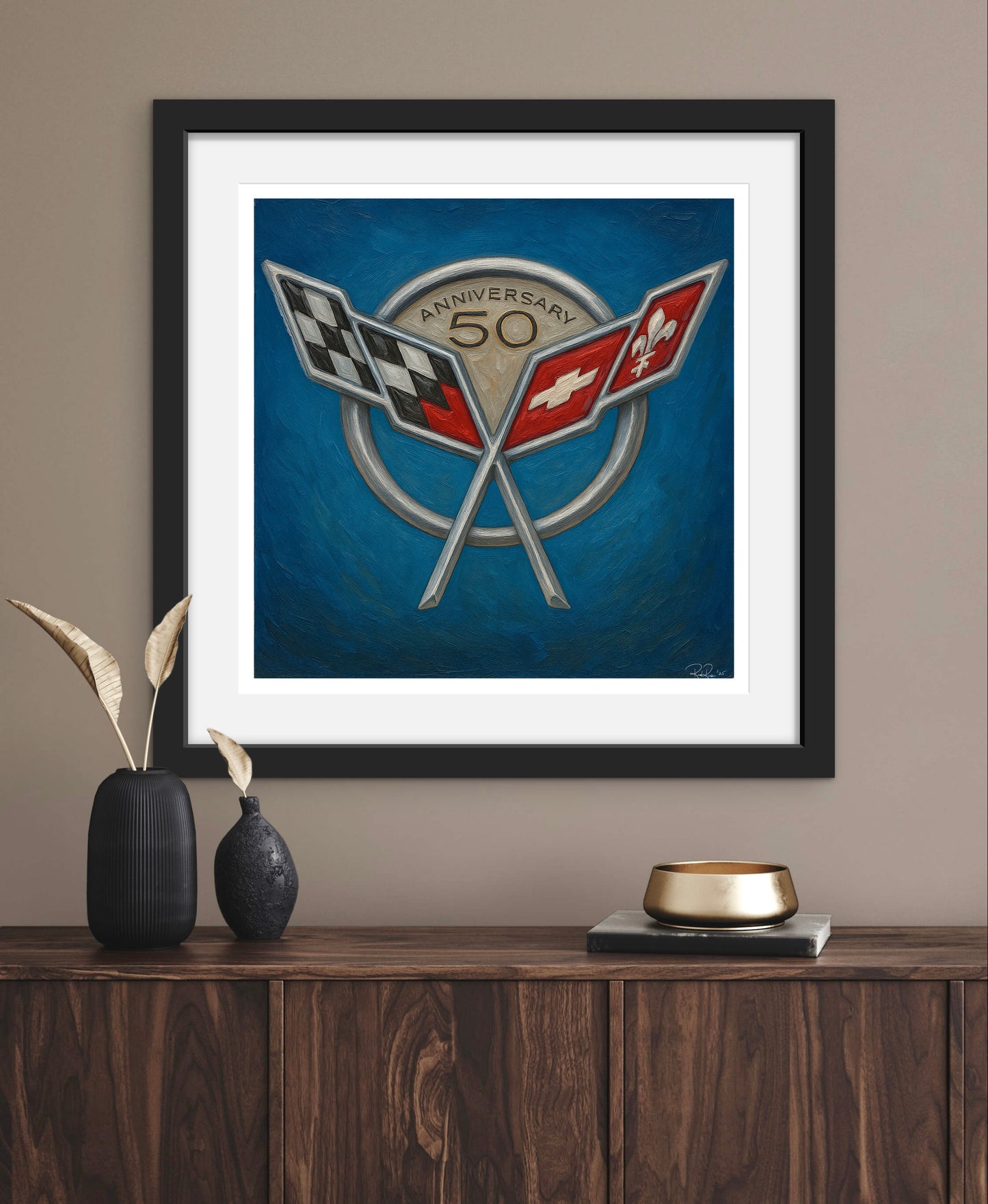 Framed artwork with a logo on a wall above a wooden cabinet.