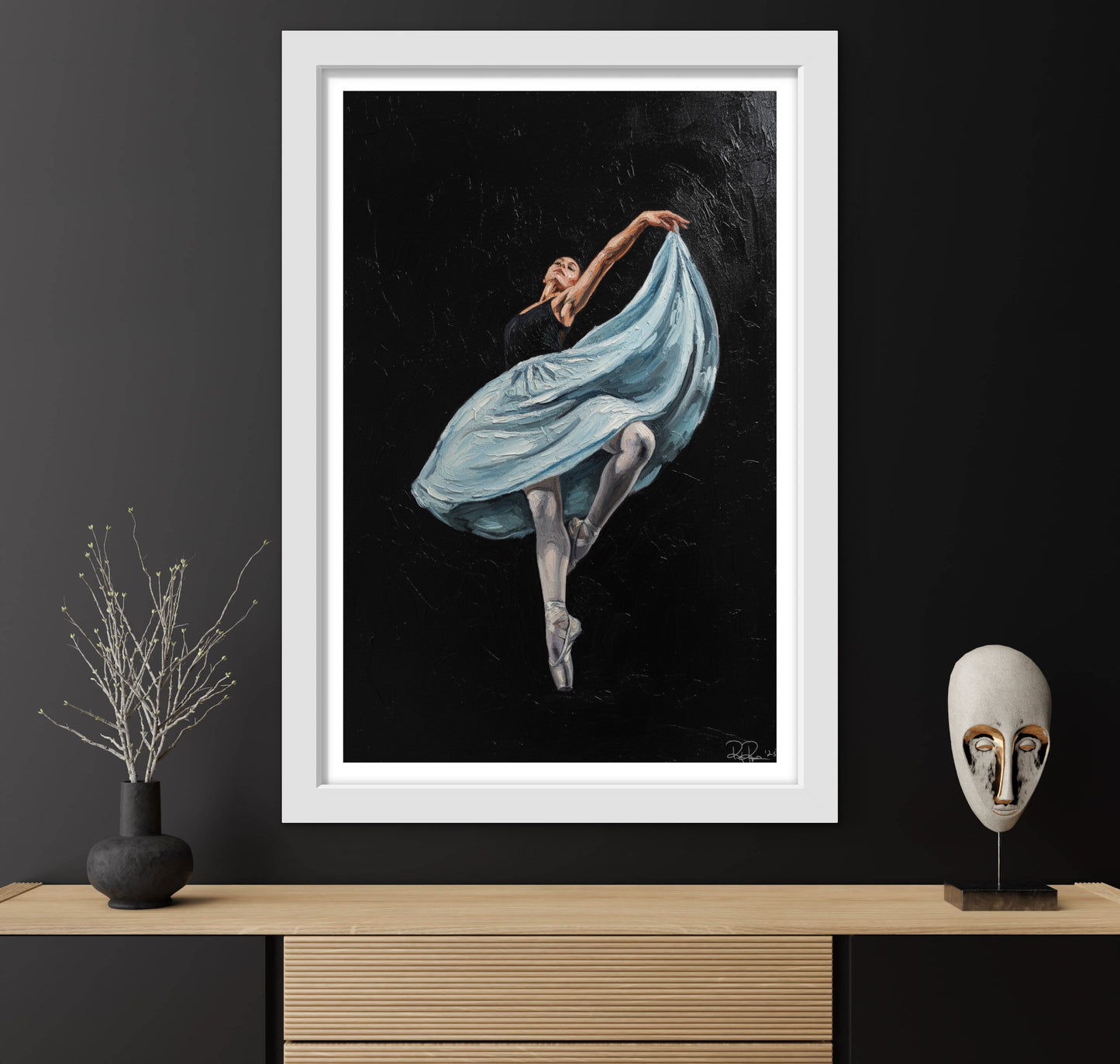 Framed artwork of a dancer in a blue dress on a dark background, displayed on a wooden shelf with decorative items.