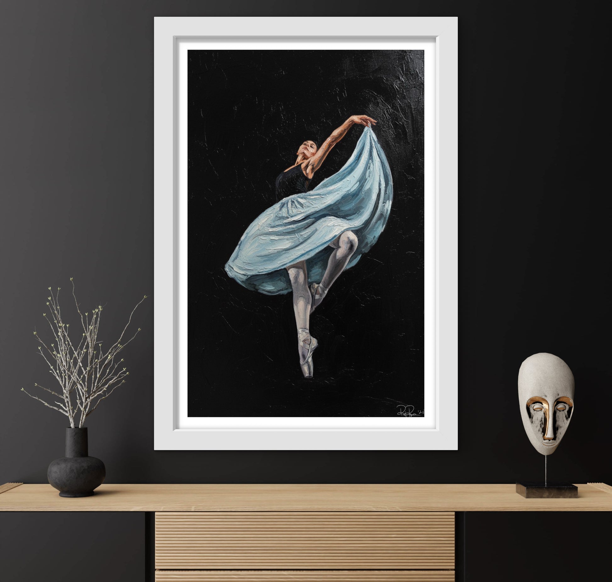 Framed artwork of a dancer in a blue dress on a dark background, displayed on a wooden shelf with decorative items.