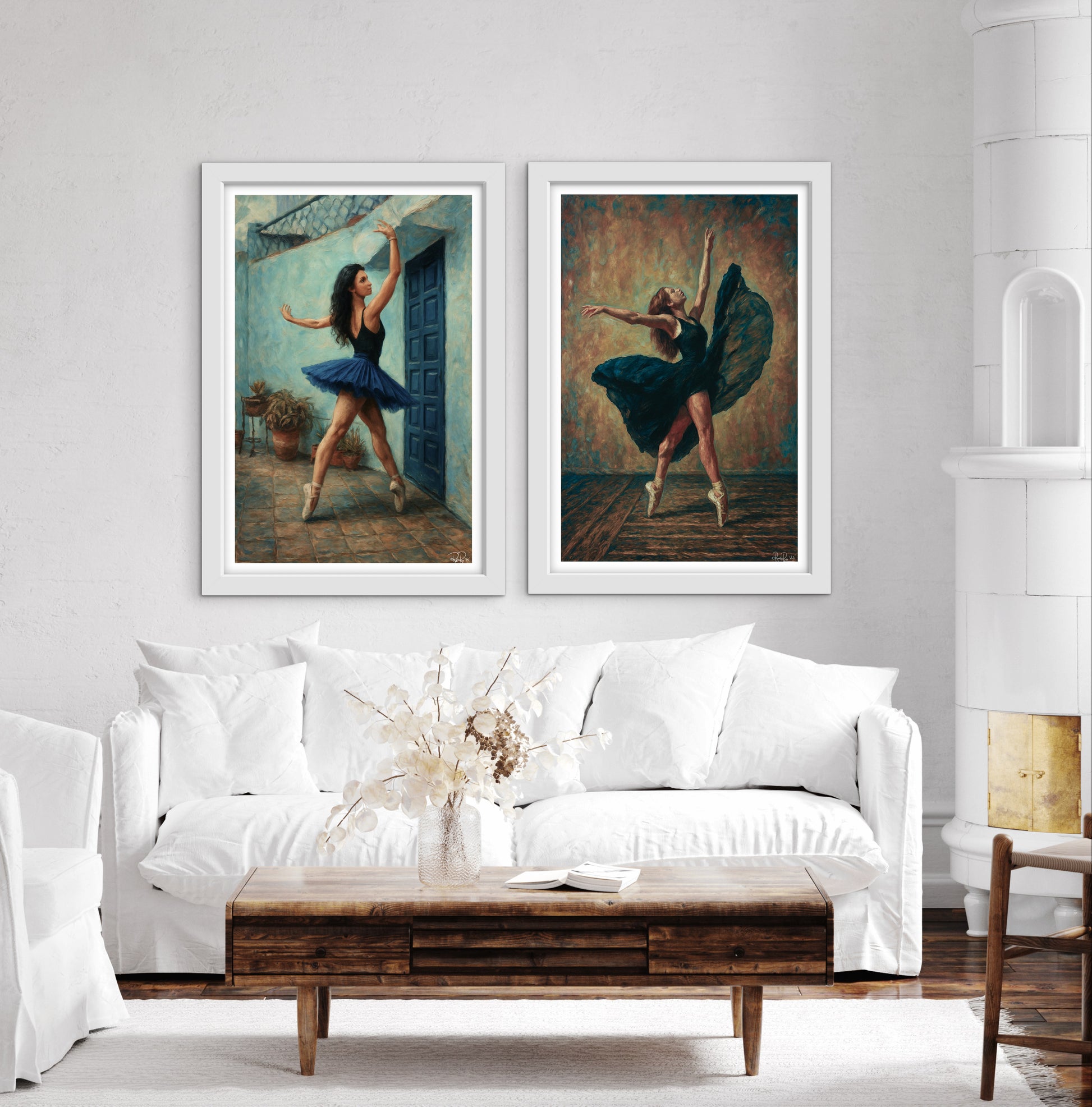Two framed paintings of ballerinas on a wall above a white sofa with a wooden coffee table.