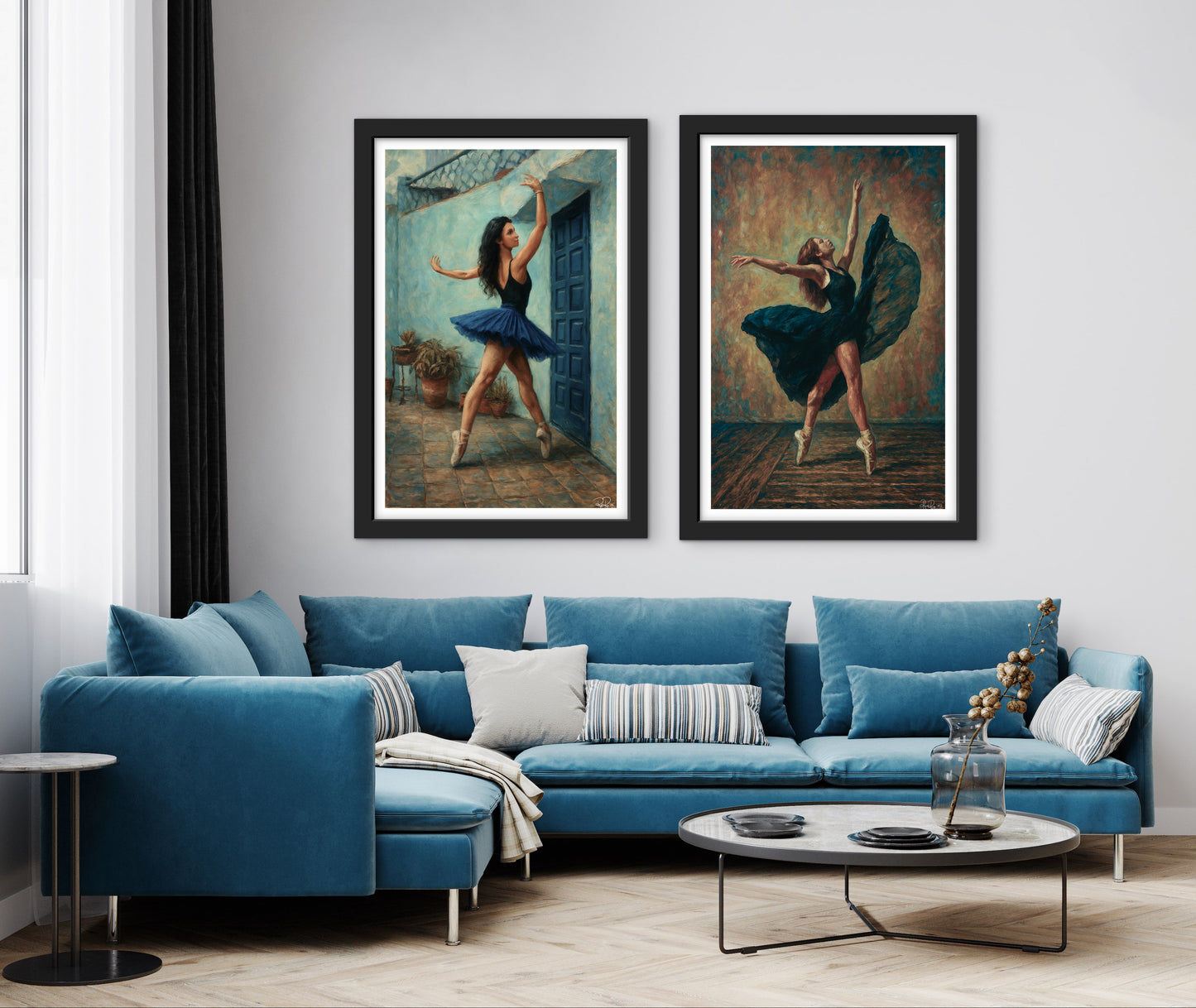 Living room with a blue sofa, round coffee table, and framed ballet dancer art on the wall.