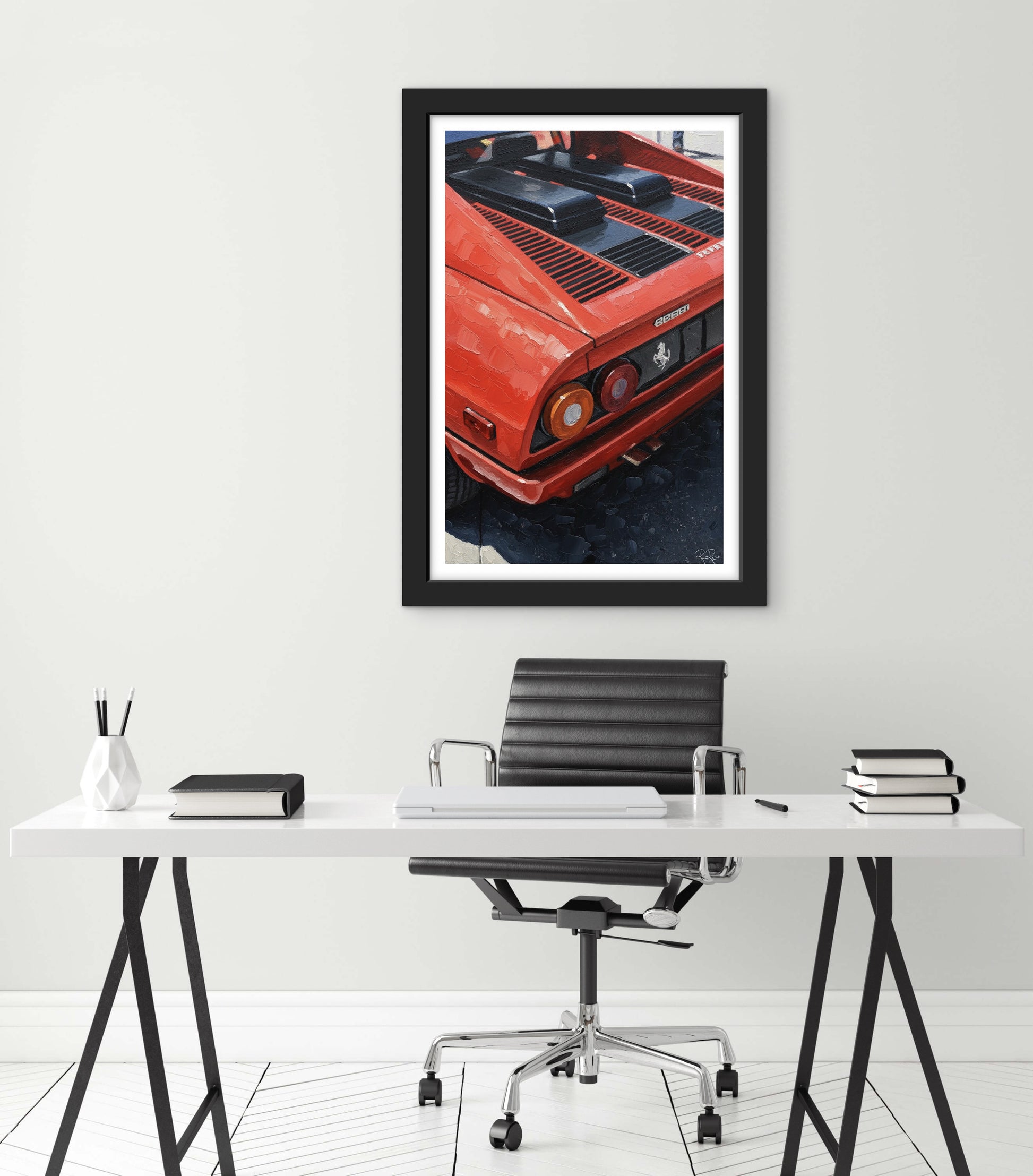 Framed print of a red car on a white wall above a desk with office furniture.