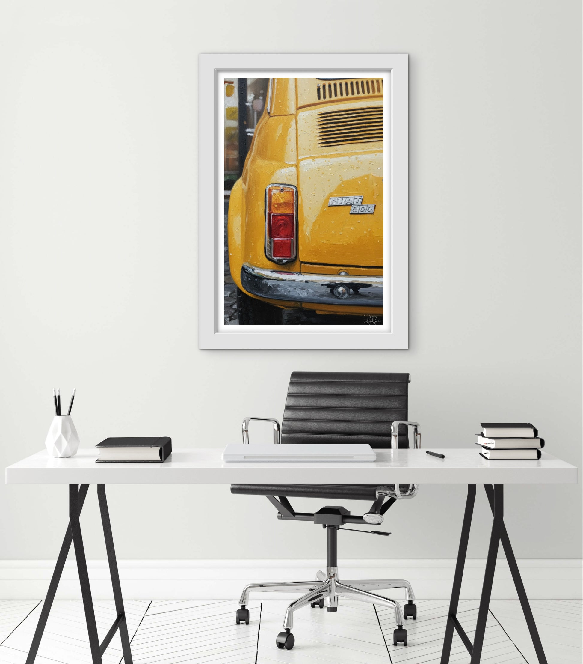 Yellow car framed print on a white wall above a desk with office furniture.