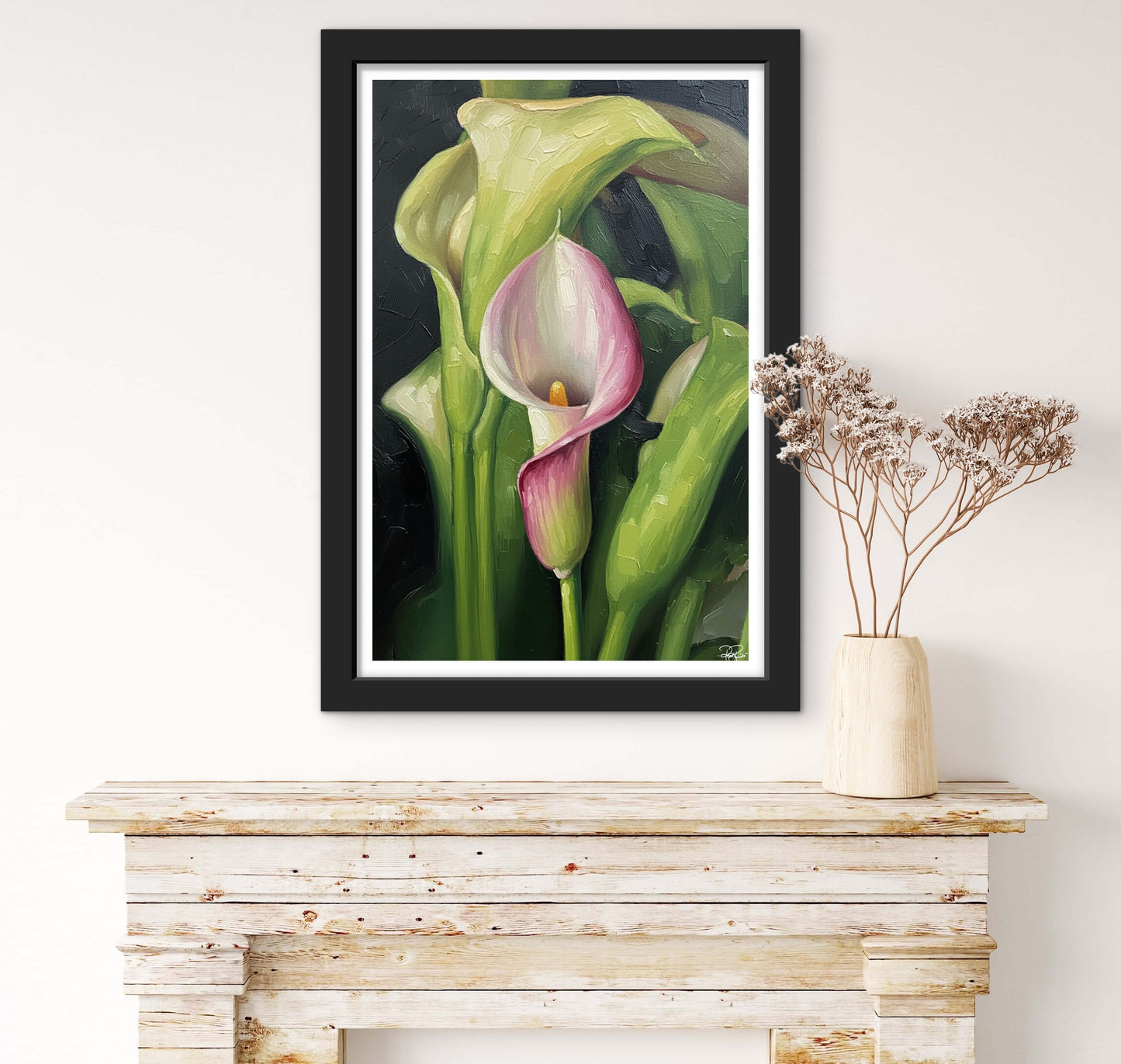 Framed artwork of a calla lily on a wooden console table.