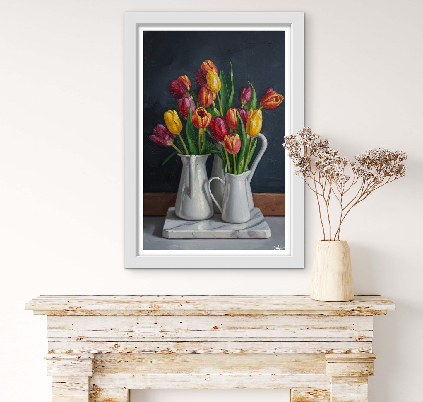 Framed painting of tulips on a wooden surface with a vase of dried flowers.