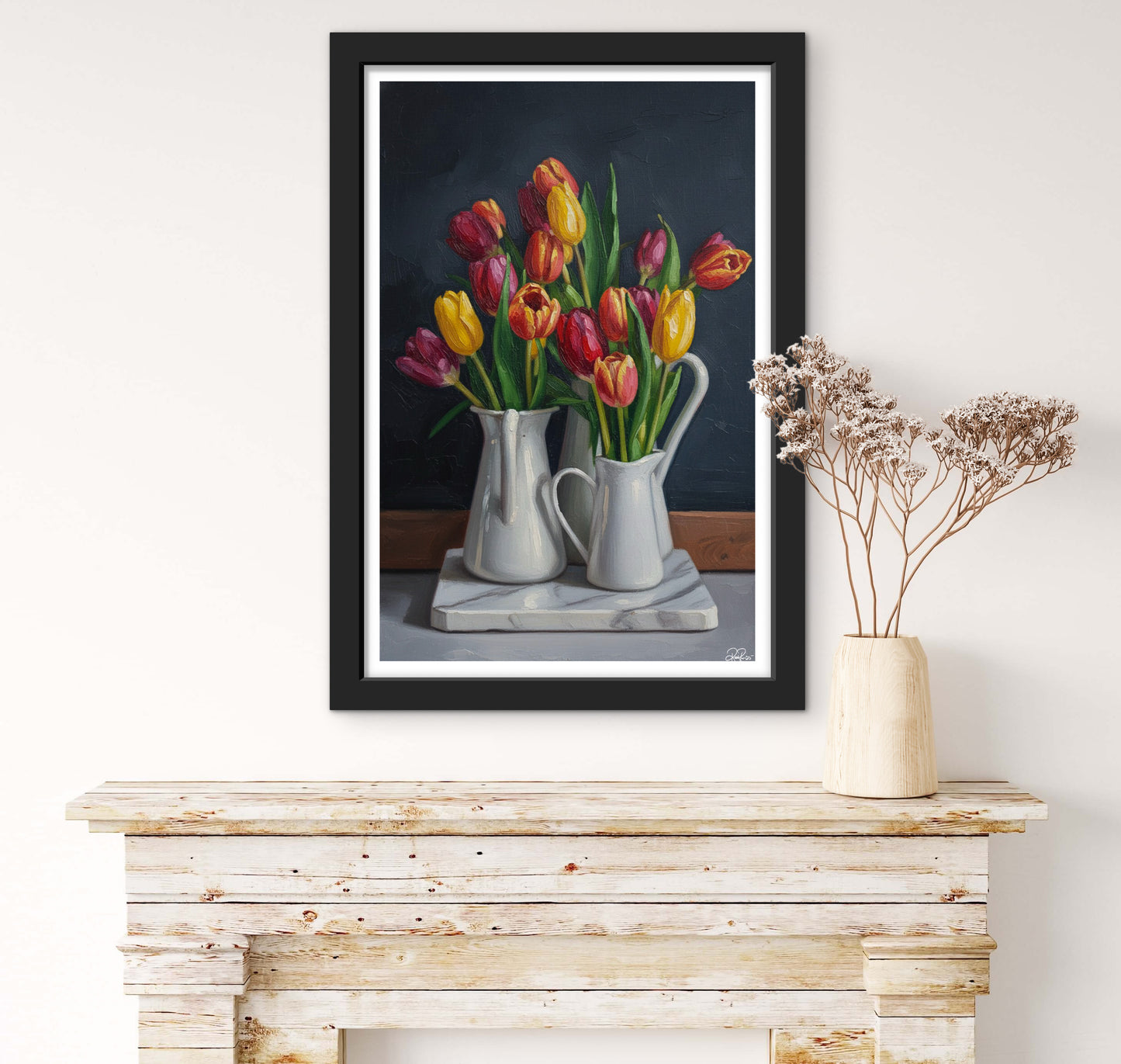 Framed artwork of tulips on a wooden console table with a vase of dried flowers.
