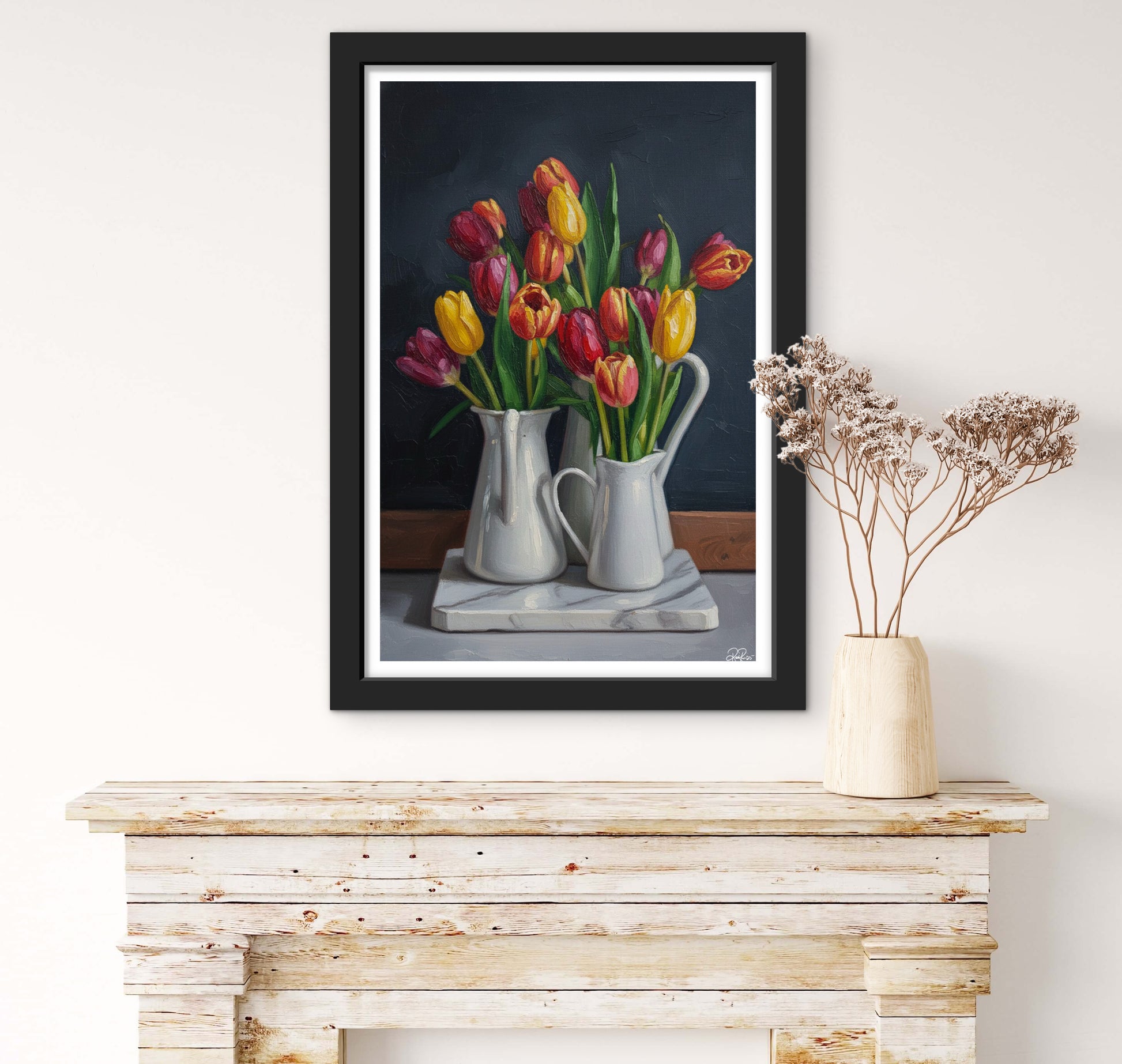 Framed artwork of tulips on a wooden console table with a vase of dried flowers.