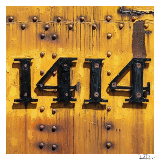 Black house numbers '1414' on a yellow background with rivets