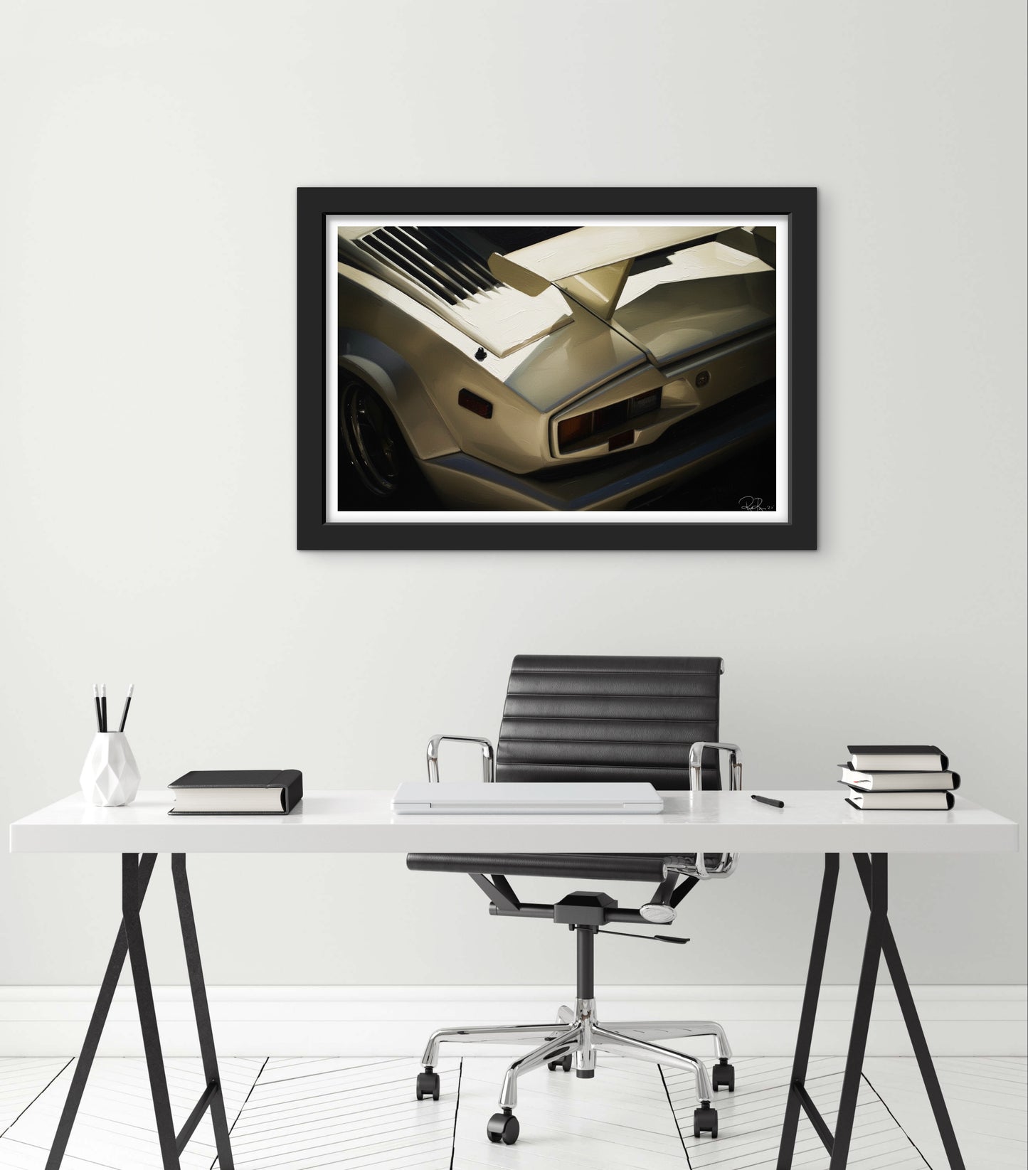 Framed artwork of a car on a wall above a desk with office chair.